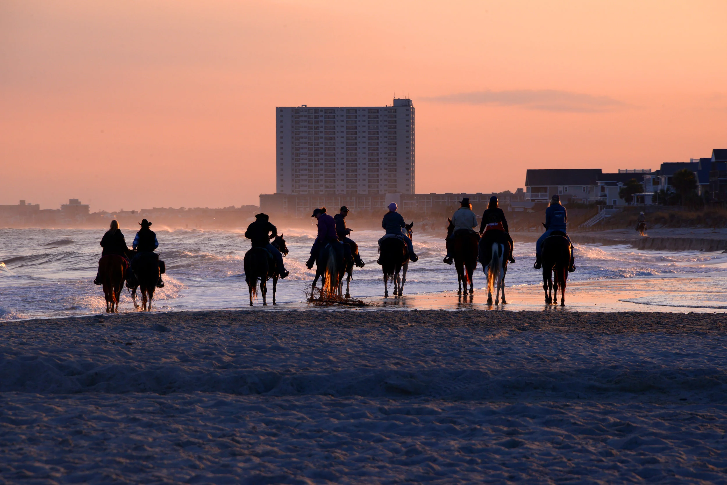 Myrtle Beach horseback riders at sunset