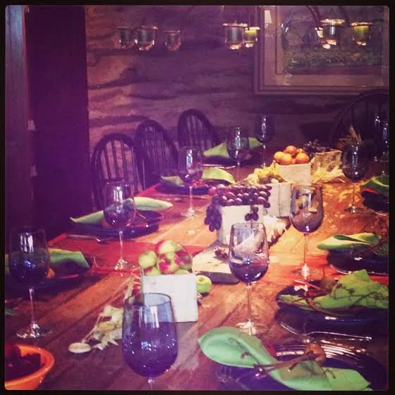 Harvest season table with edible decor and grapevine napkin rings.