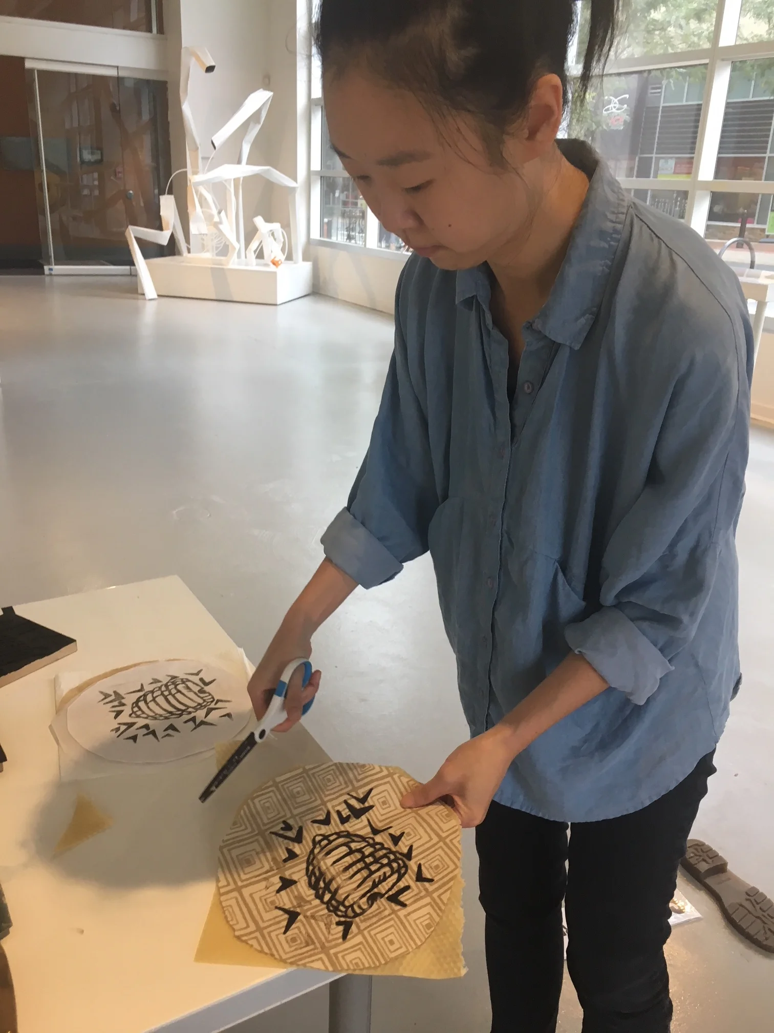 Susanna Lee, staff member at VisArt Art Center in Rockville finishing up her Food Wrap before workshop attendees arrive.