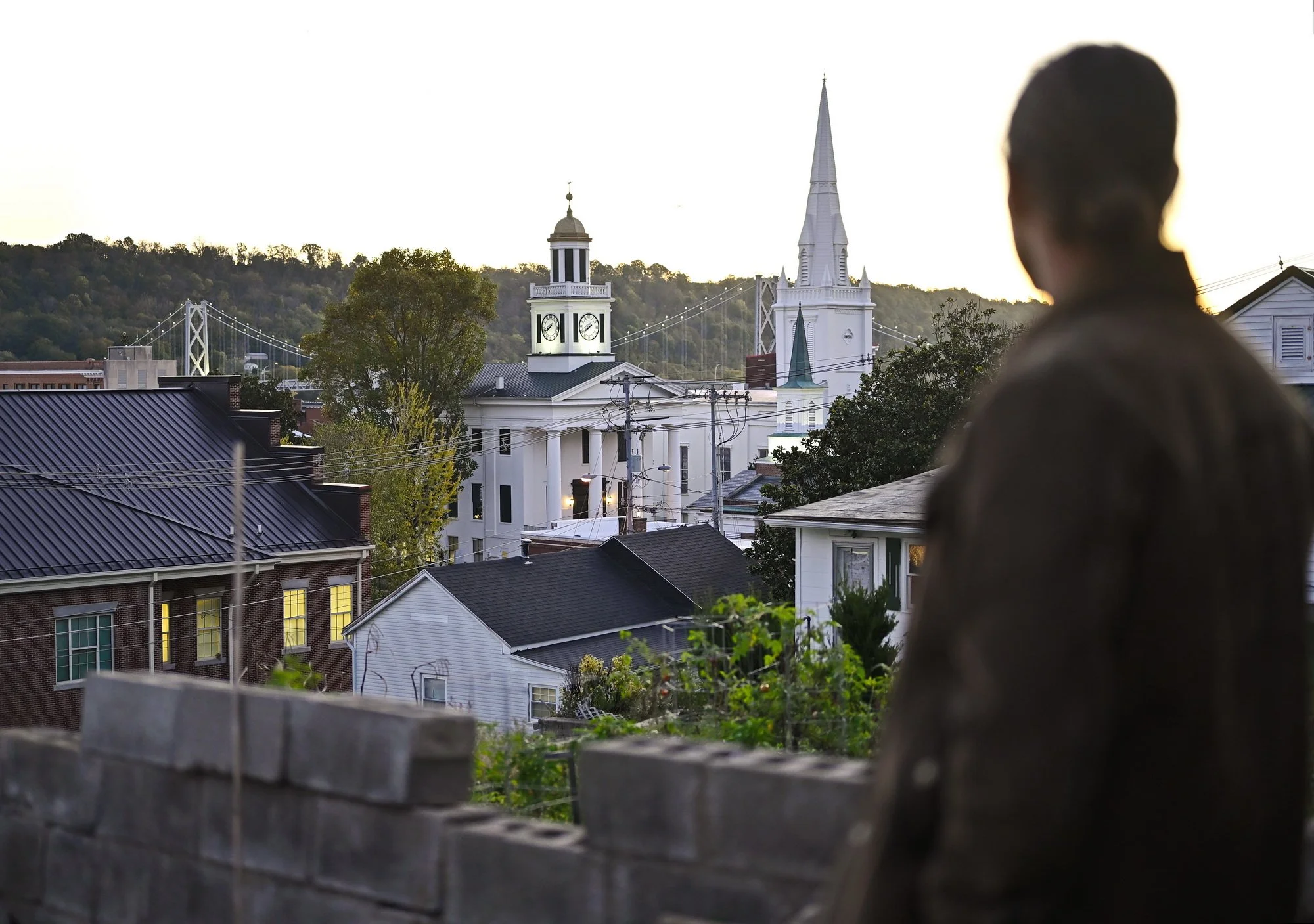  John Meng, 46, a Maysville native,  looks over the Maysville downtown  and the Ohio River from The Headmaster’s House on Fourth Street, a 192-year-old Federalist-style home he and his wife are restoring. He comes to the house in the mornings to fill
