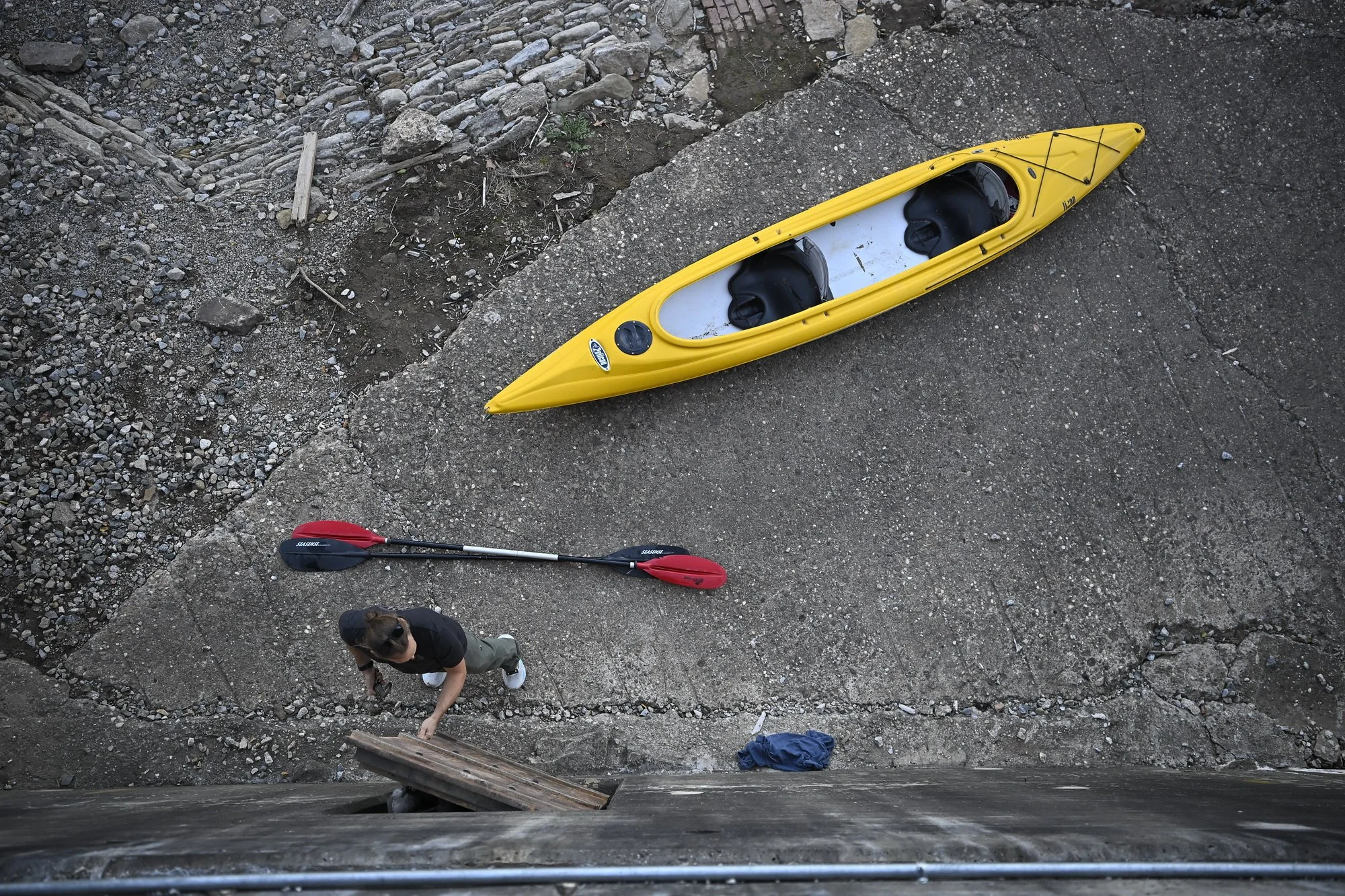  John Meng, 46, closes the door of the old train trestle in the Maysville  flood wall, which he converted into a storage space for his  watersports venture, Hole in the Wall Kayaking. Meng had to clean 4 feet of decades' worth of mud from the area to