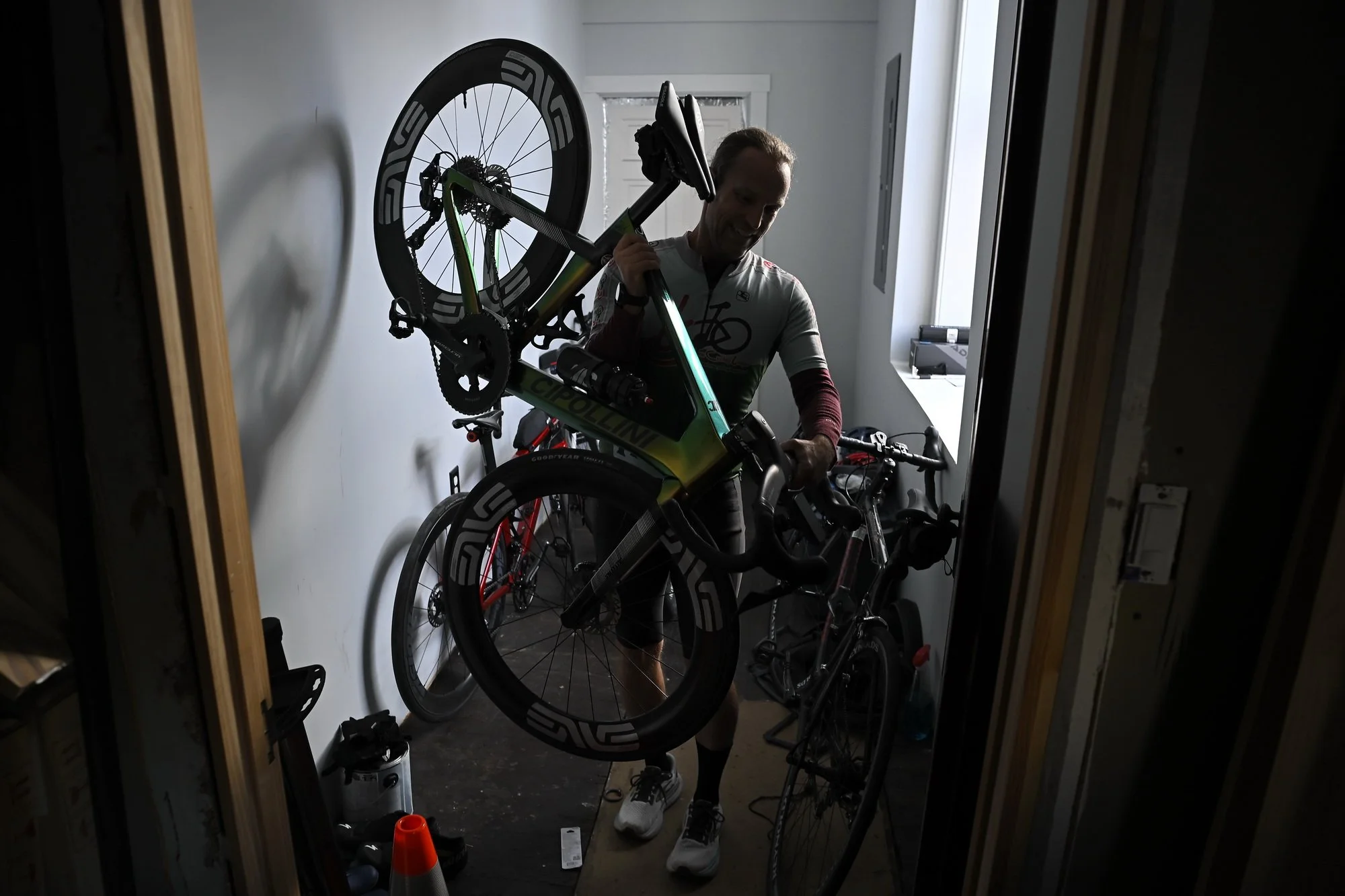  Maysville native  John Meng, 46, smiles as he carries his bicycle  from his home to get ready for a group ride on Wednesday evening—a last outdoor ride as the temperatures dropped. Meng says only those willing to embrace human-powered sports will un