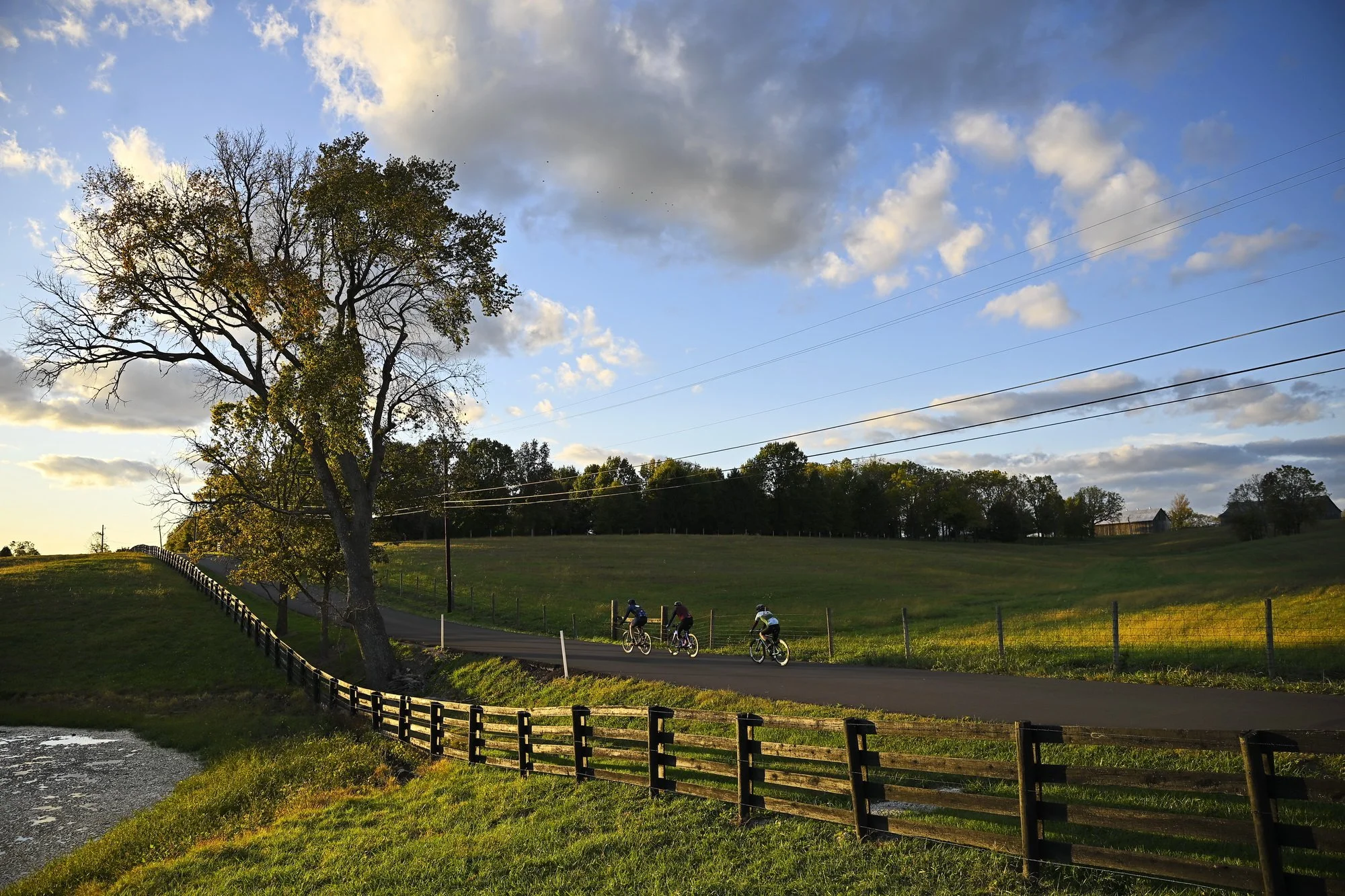  John Meng (right)  rides along a scenic backroad in Mason County  at sunset together with his friends Marc Pawsat (59), and Kyle Pitakis (36), both from Maysville, who have been riding together for about 7 or 8 years. Meng is passionate about the lo