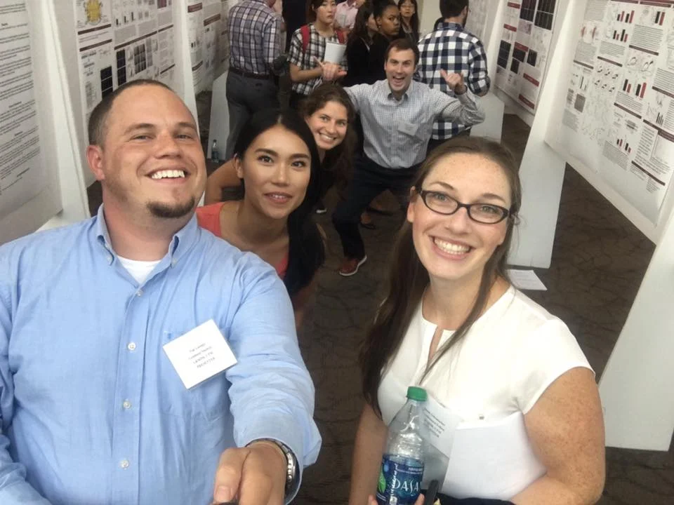 Tim uses his selfie stick to take a pictures of the lab during the Dawn Marks Day poster presentation 