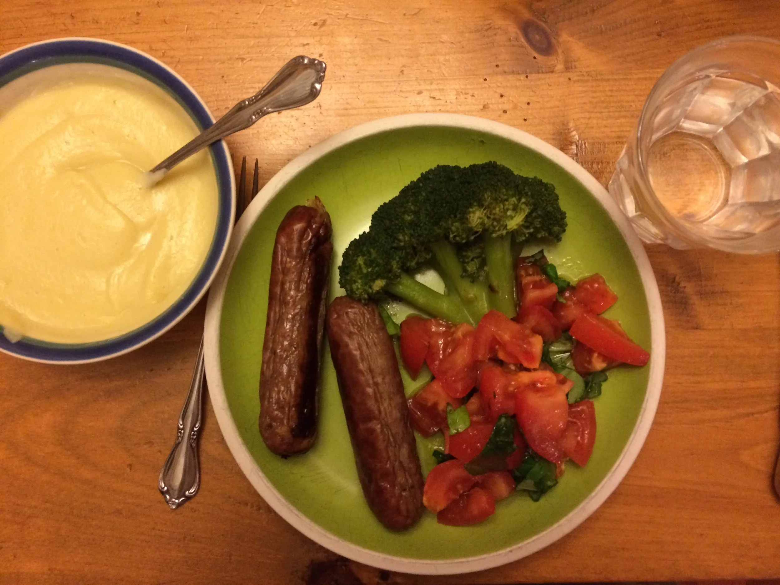 This meal is GAPS and SCD compliant. I have some Sunworks sausage, a Tomato and Basil salad with olive oil, a piece of broccoli, and a bowl of cauliflower soup. Not many carbs here.