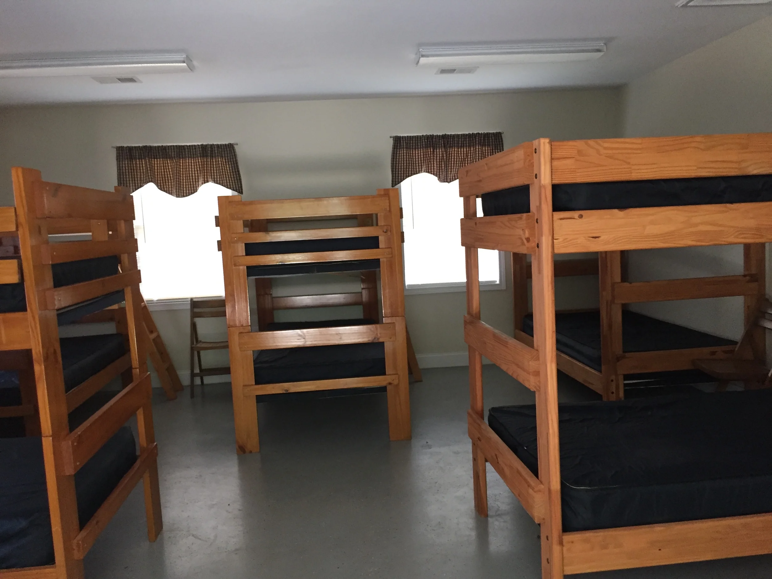 Bunk cabins sleep 12 people. They include 3 showers, sinks, and toilets.