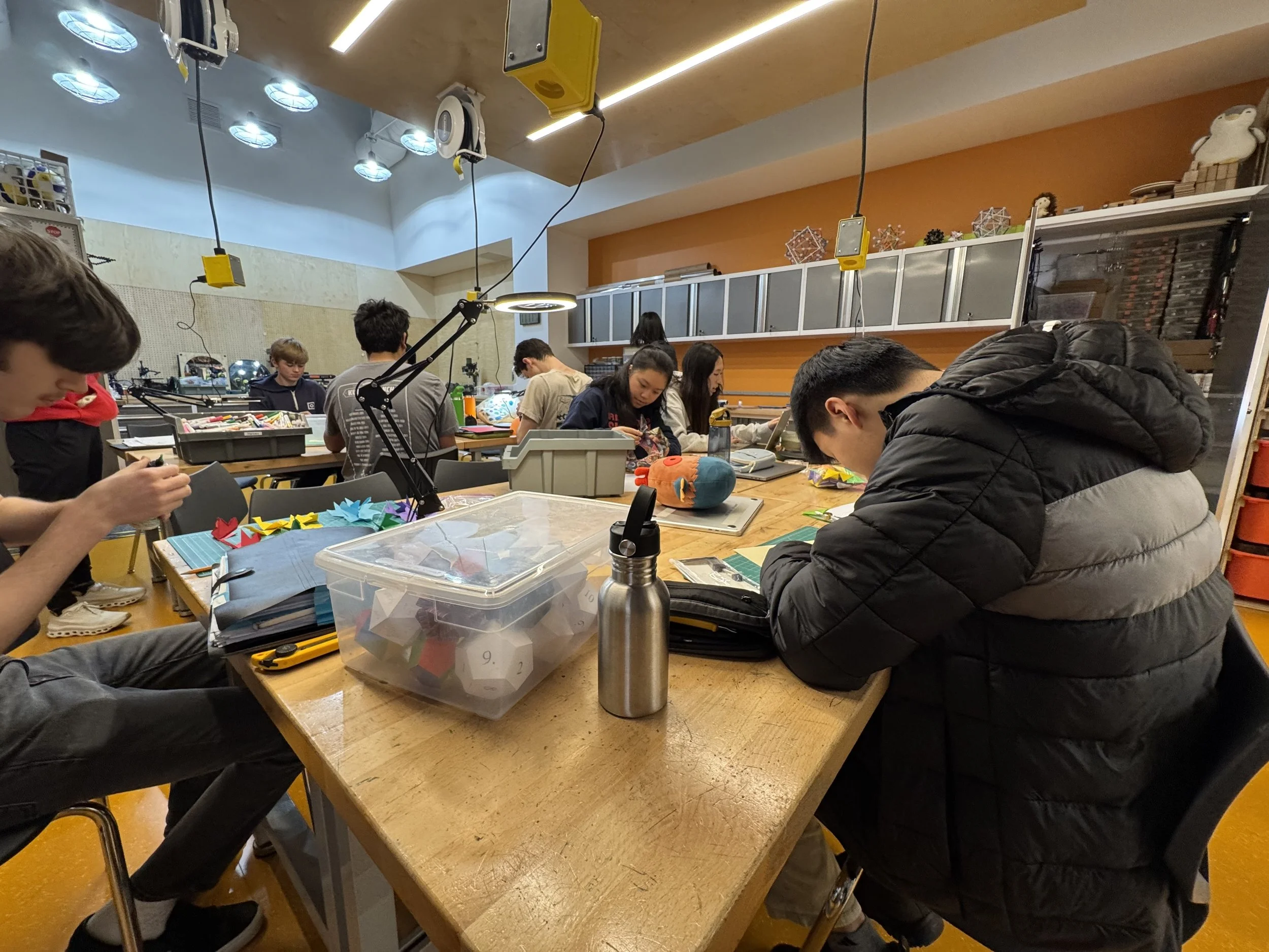 Students working on origami in a workshop