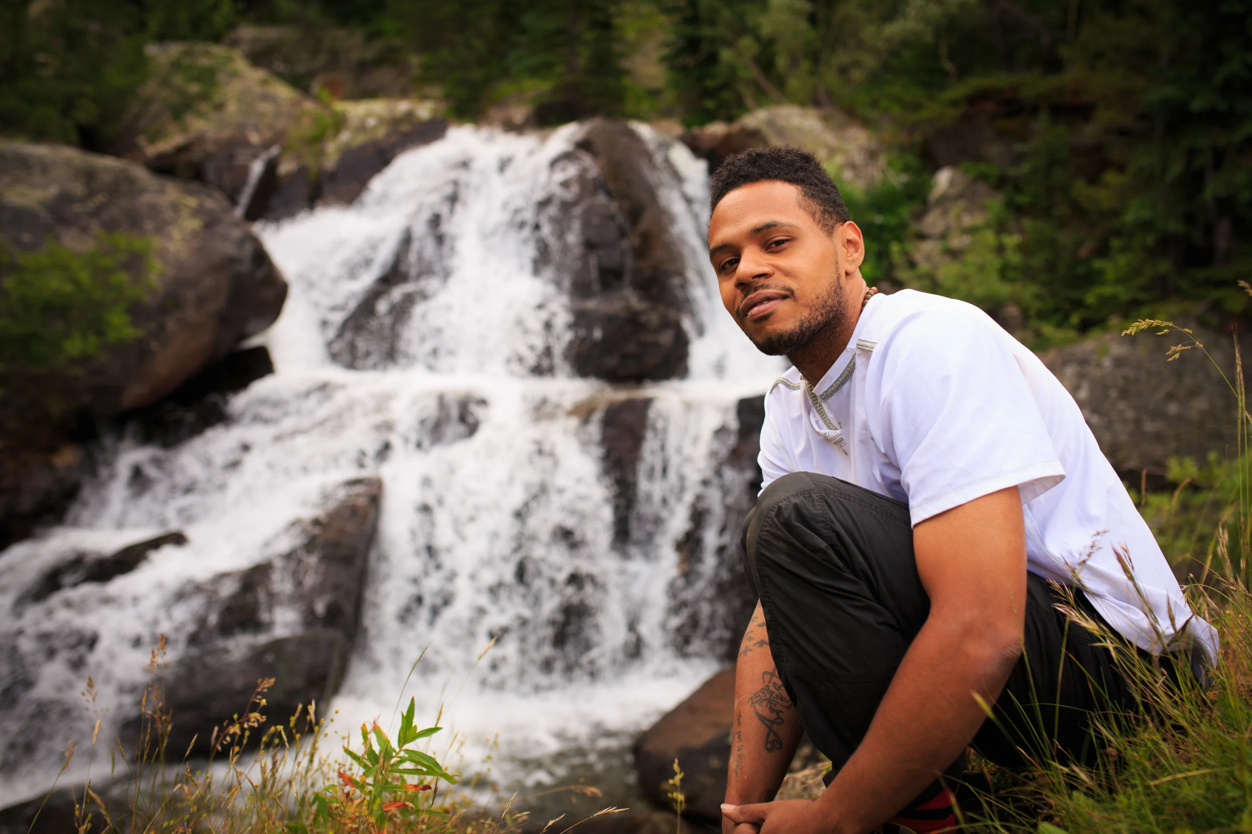 Anthony DeJesus poses by a waterfall in Colorado's Indian Peaks Wilderness Area during production of the documentary film Rewilding . Download a High Resolution JPEG Image (4.37 MB)