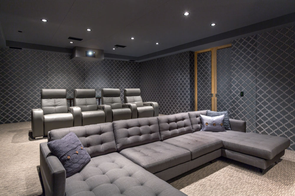 Luxurious grey leather couches and home theater chairs
