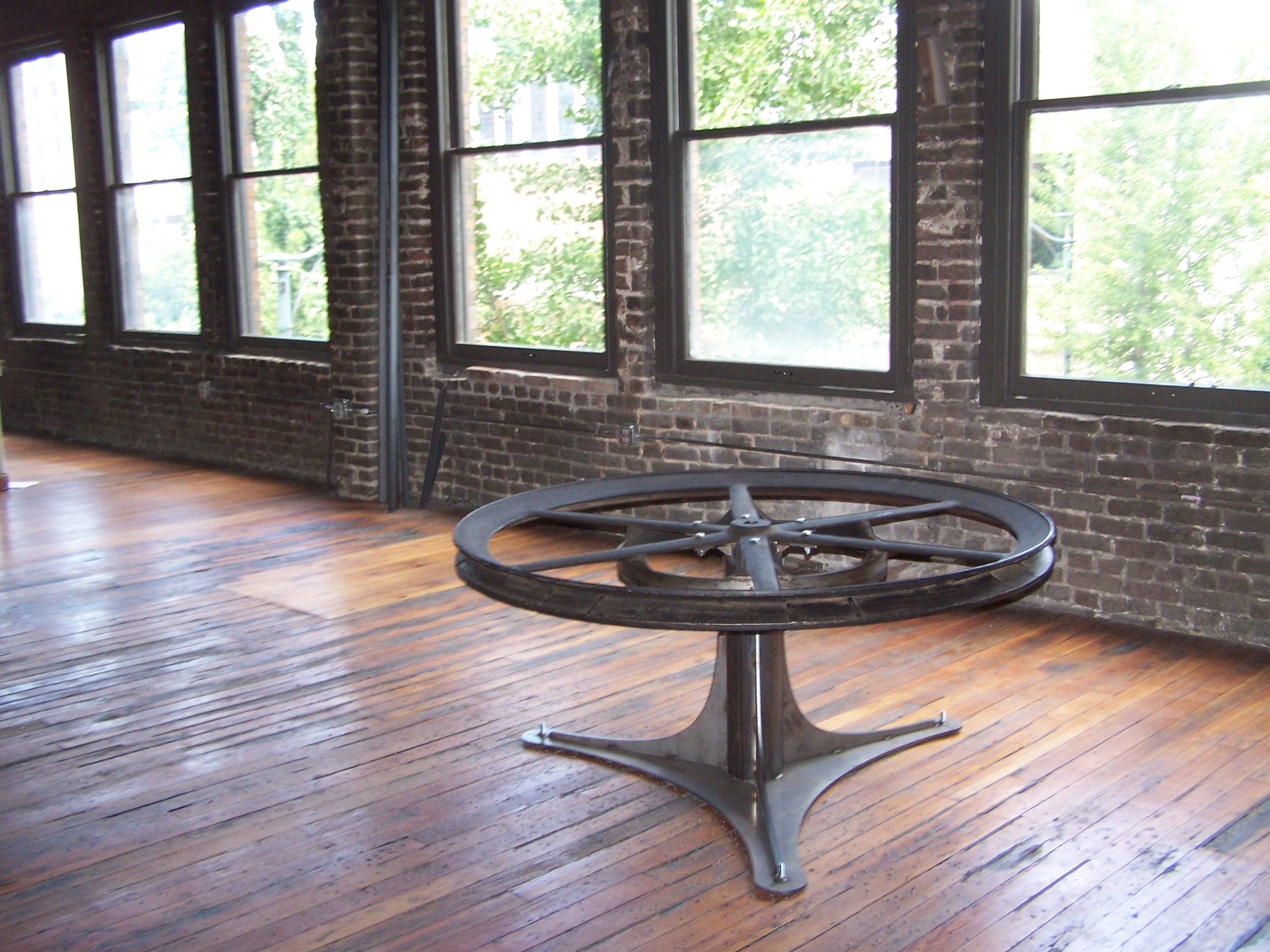 Table made out of elevator pulley wheel