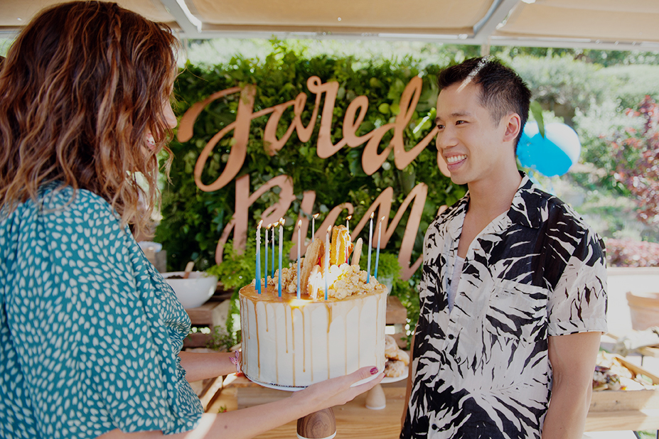 Actress, Georgie Flores, presents Jared with his birthday cake, as his friends sang "Happy Birthday."