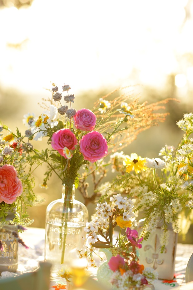 Centerpieces with jars, wildflowers and roses