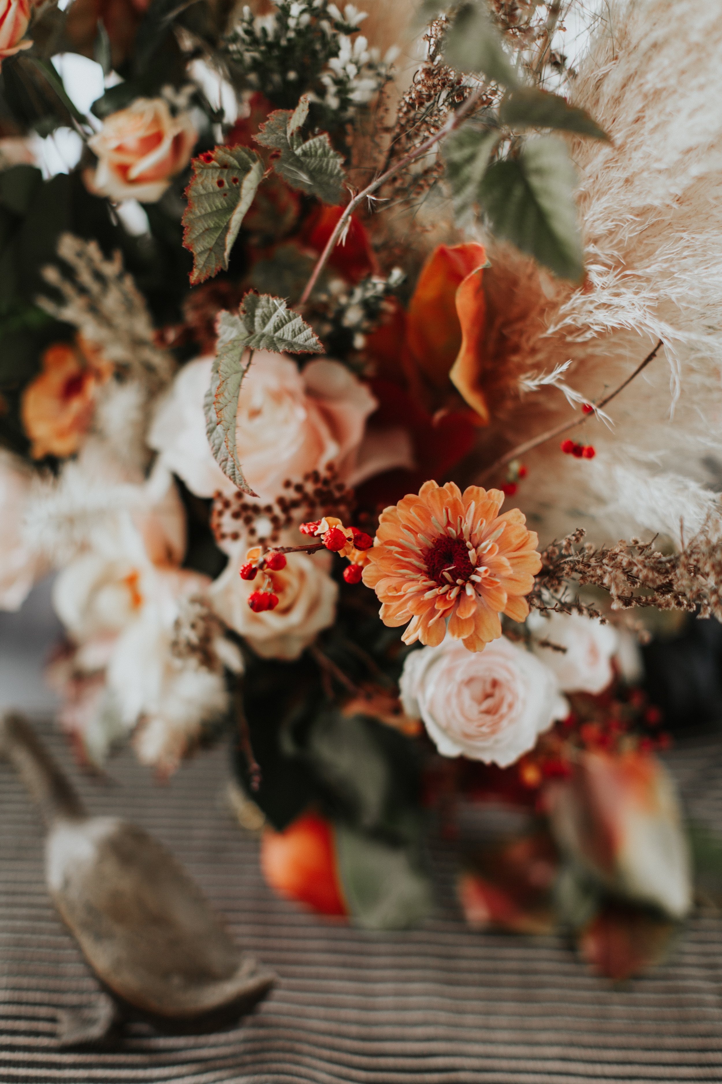 Centerpiece with Zinnias, Garden Roses, foraged raspberry vines and berries