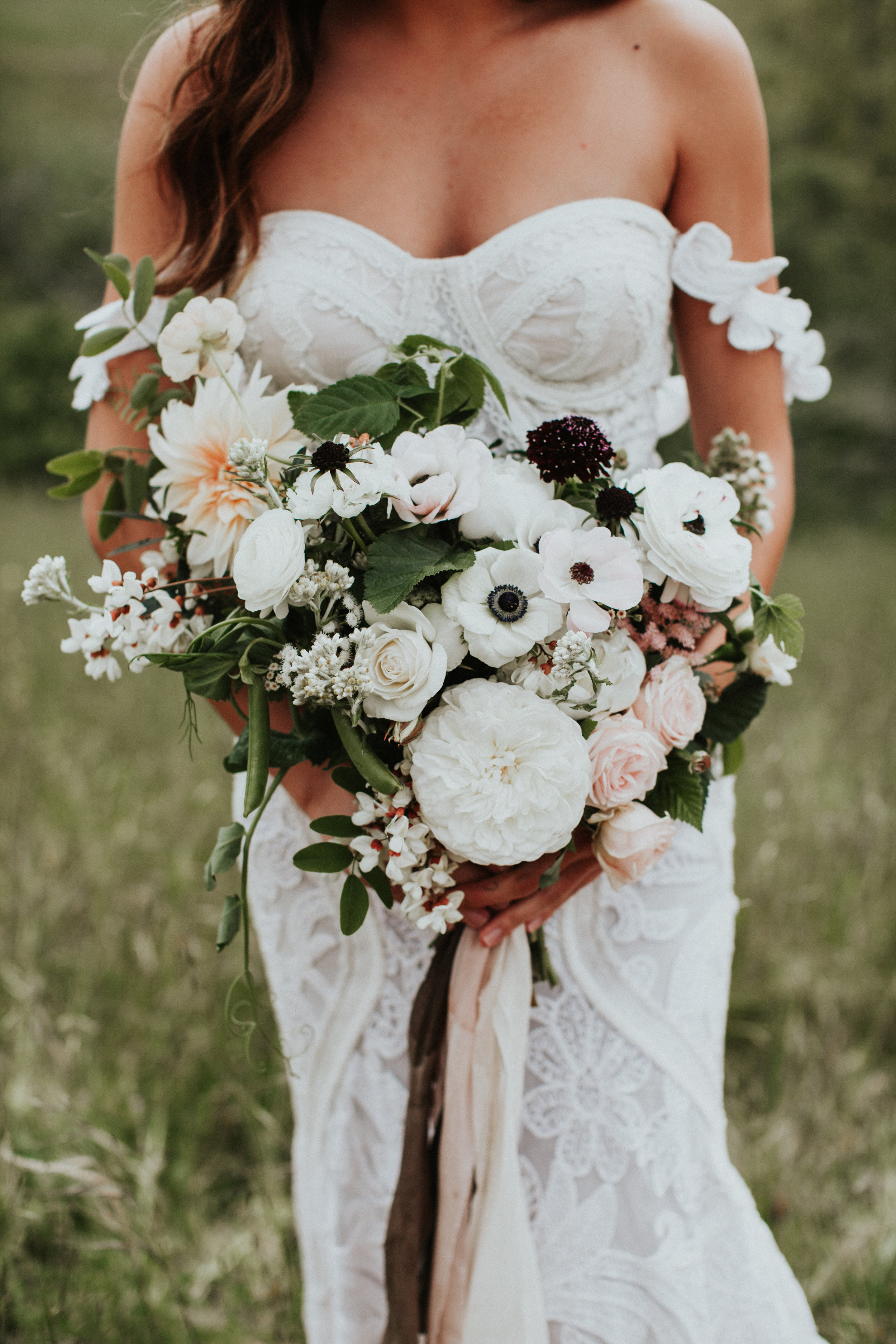 White and cream garden roses, Cafe Au Lait, anemones, and wisteria