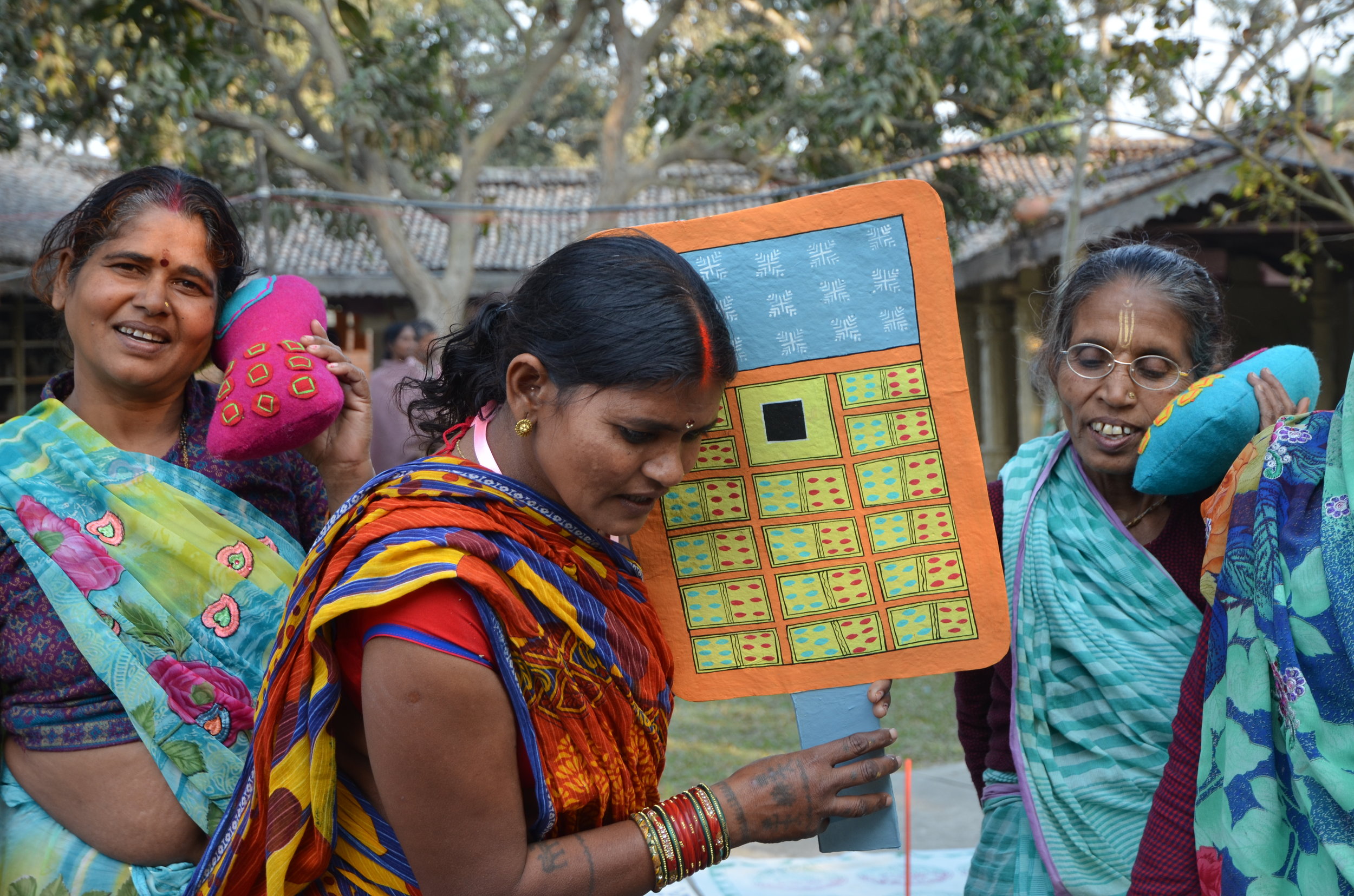 “We use mobile phones to connect to our families.” Pano, Madhumala and Ukha practice their performance for the WOW event. 