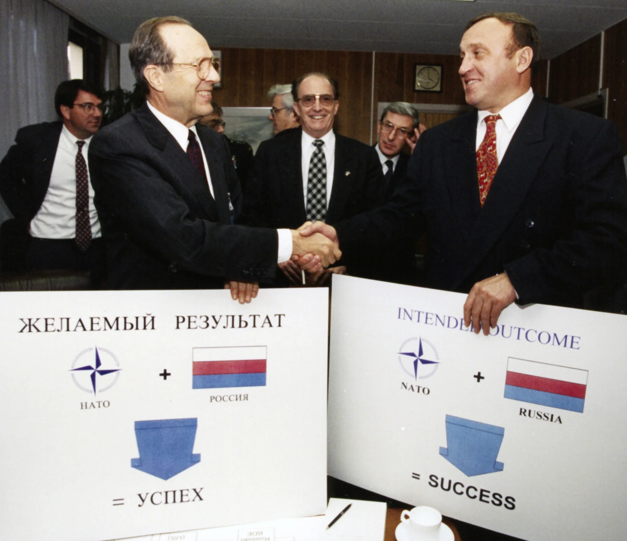 "Russia + NATO = Success." Perry and Russian defense minister Grachev sign Bosnia agreement at NATO headquarters in Brussels, November 1995.
