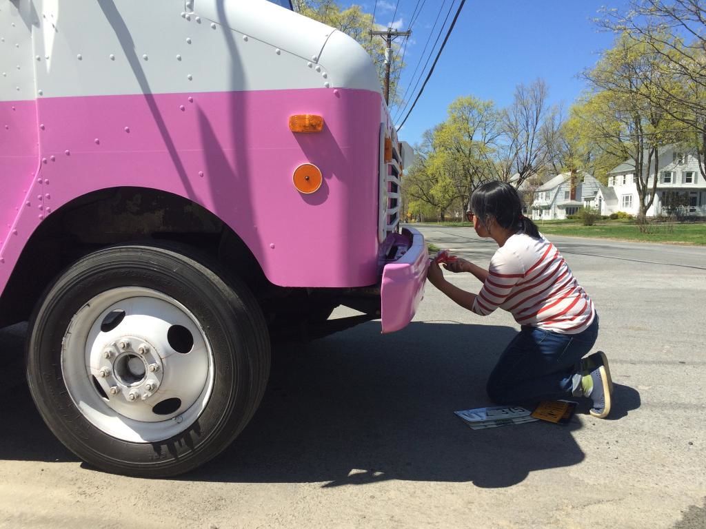 Ice cream in one hand, screwdriver in another--changing the license plates on an Ice Cream Truck for filming