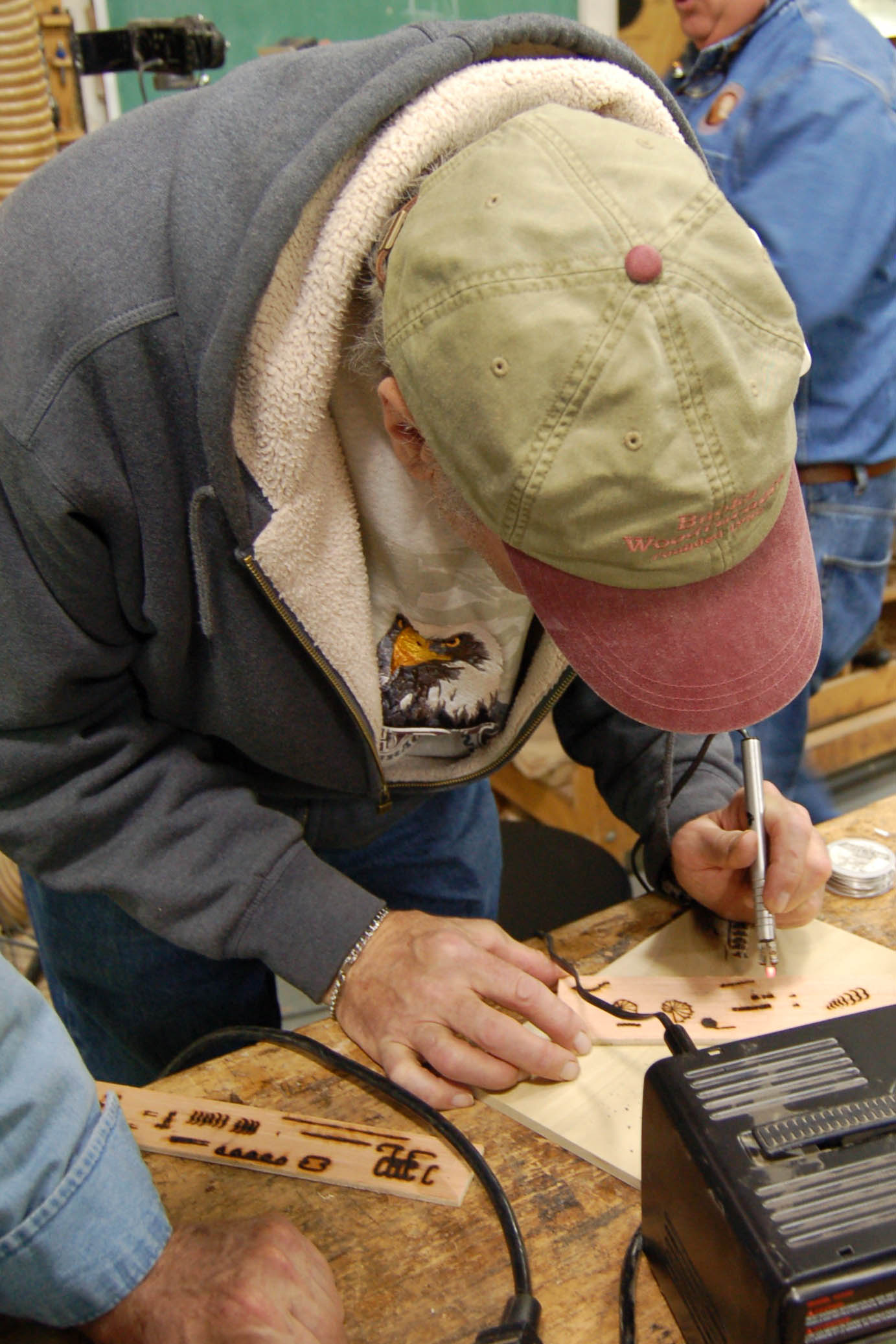 Tom tries his hand at pyrography.