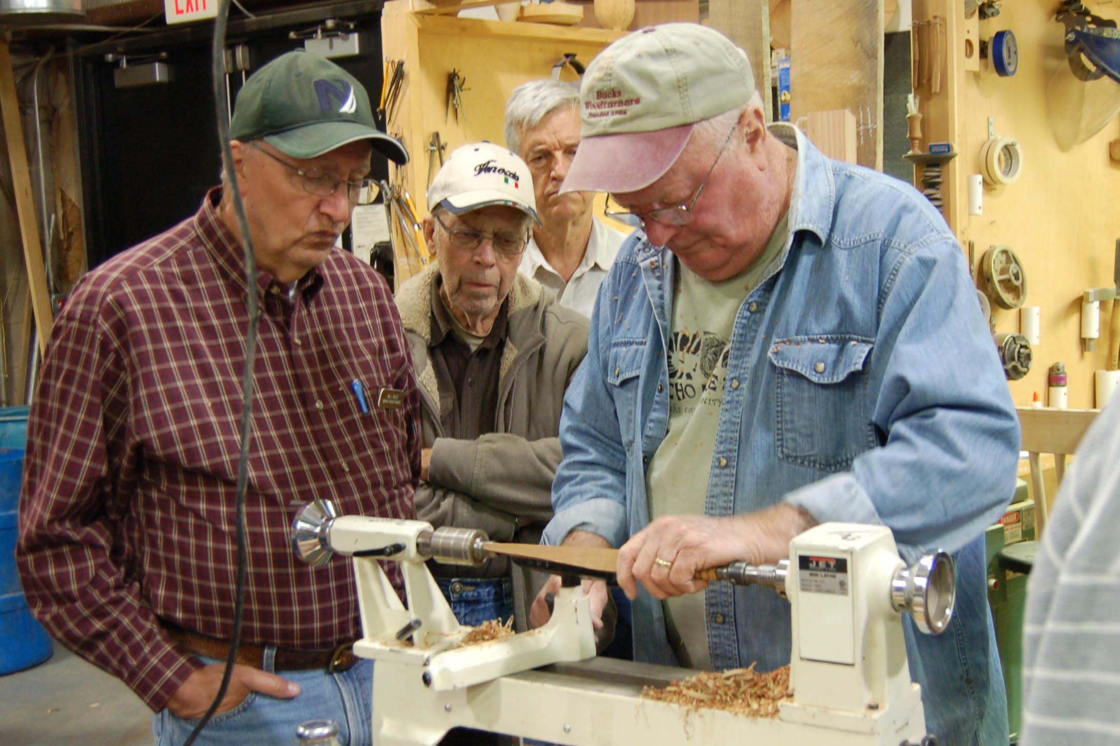  Bill Weist, Litton Frank, and Rick Baker look on as Ed works on a spatula. 