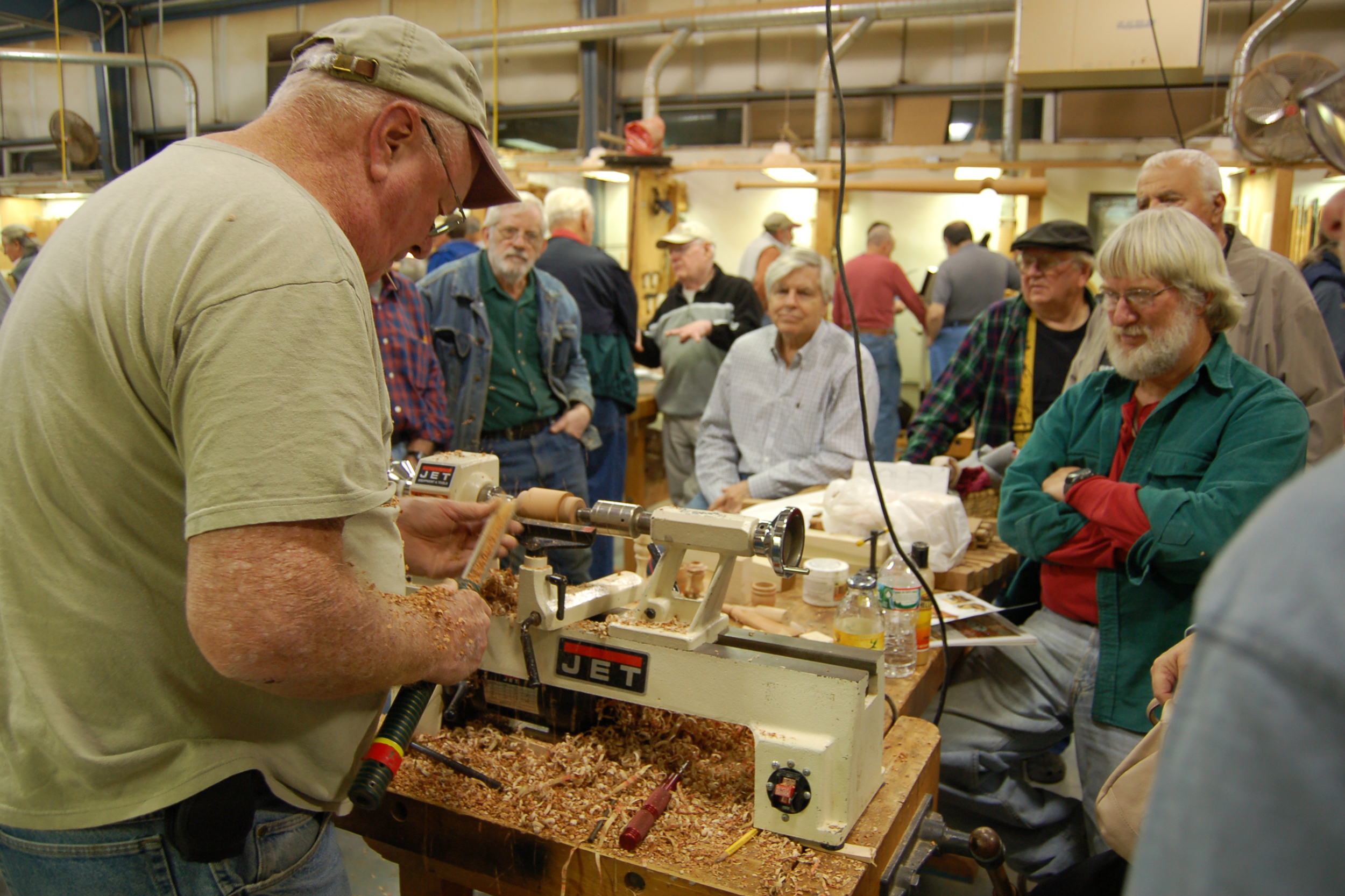  Ed Ryan attracts a big crowd as he turns some basic items ideal for small gifts. 