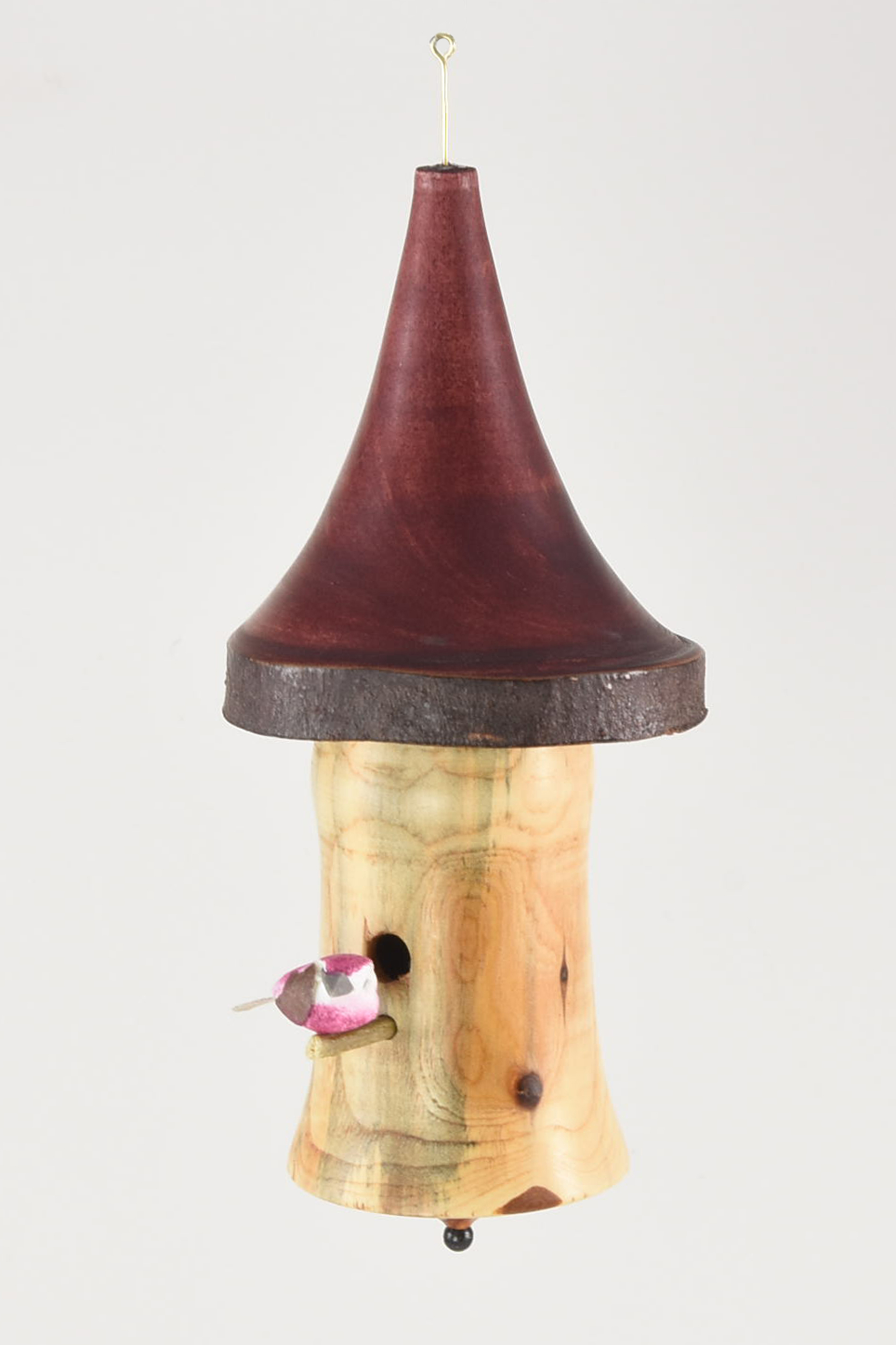 The birdhouse body is yew and the roof is from a Parrotia tree branch from my backyard, with Merlot stain. The bird is from Craft Supply. -Andy Postlewaite