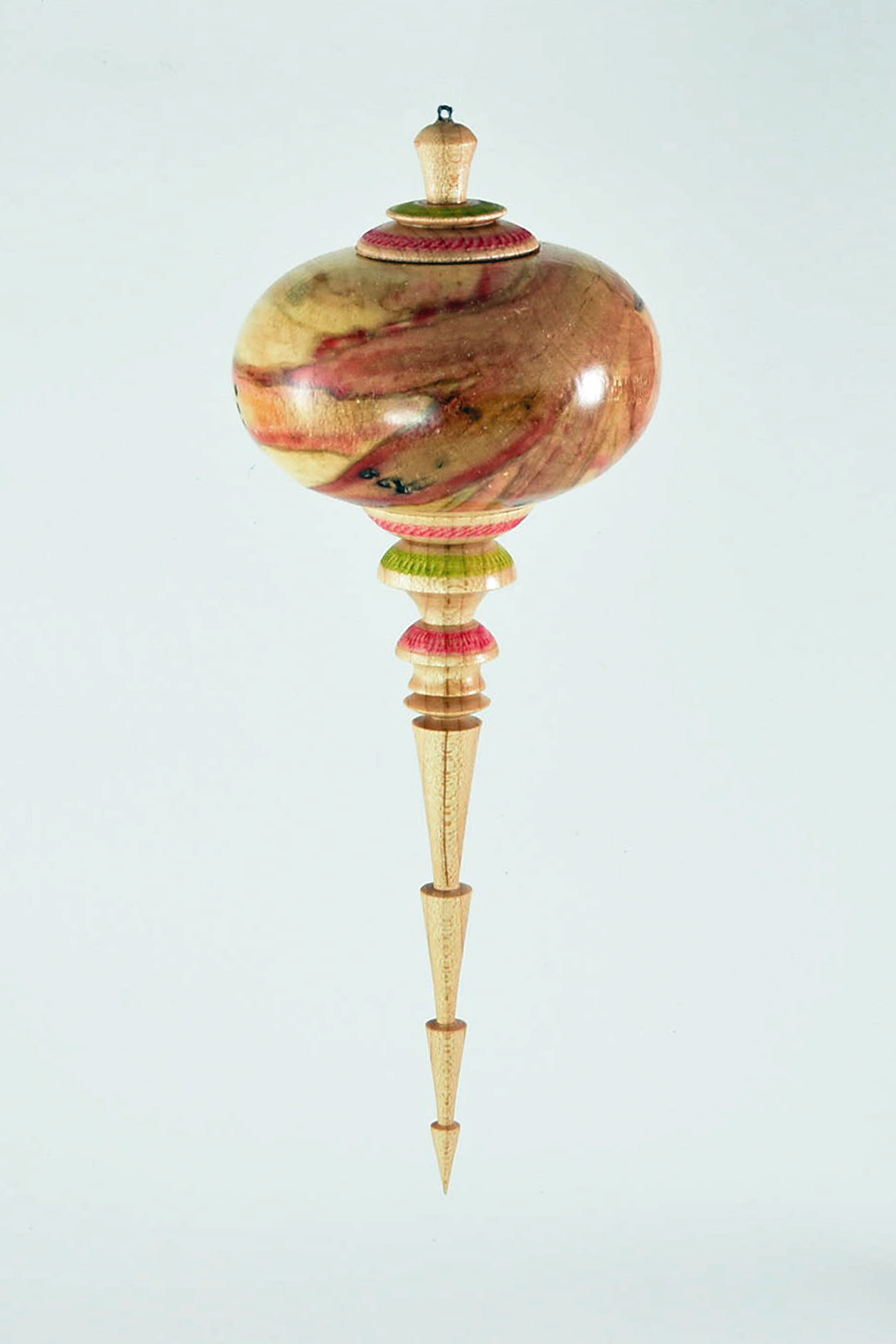 The globe of the ornament is Box Elder and the finials are maple decorated with a spiralling tool and a little color. I make one or two every Christmas for our home. Even though we do not have a tree anymore, Pat places them around the house on trays. -Ed Ryan