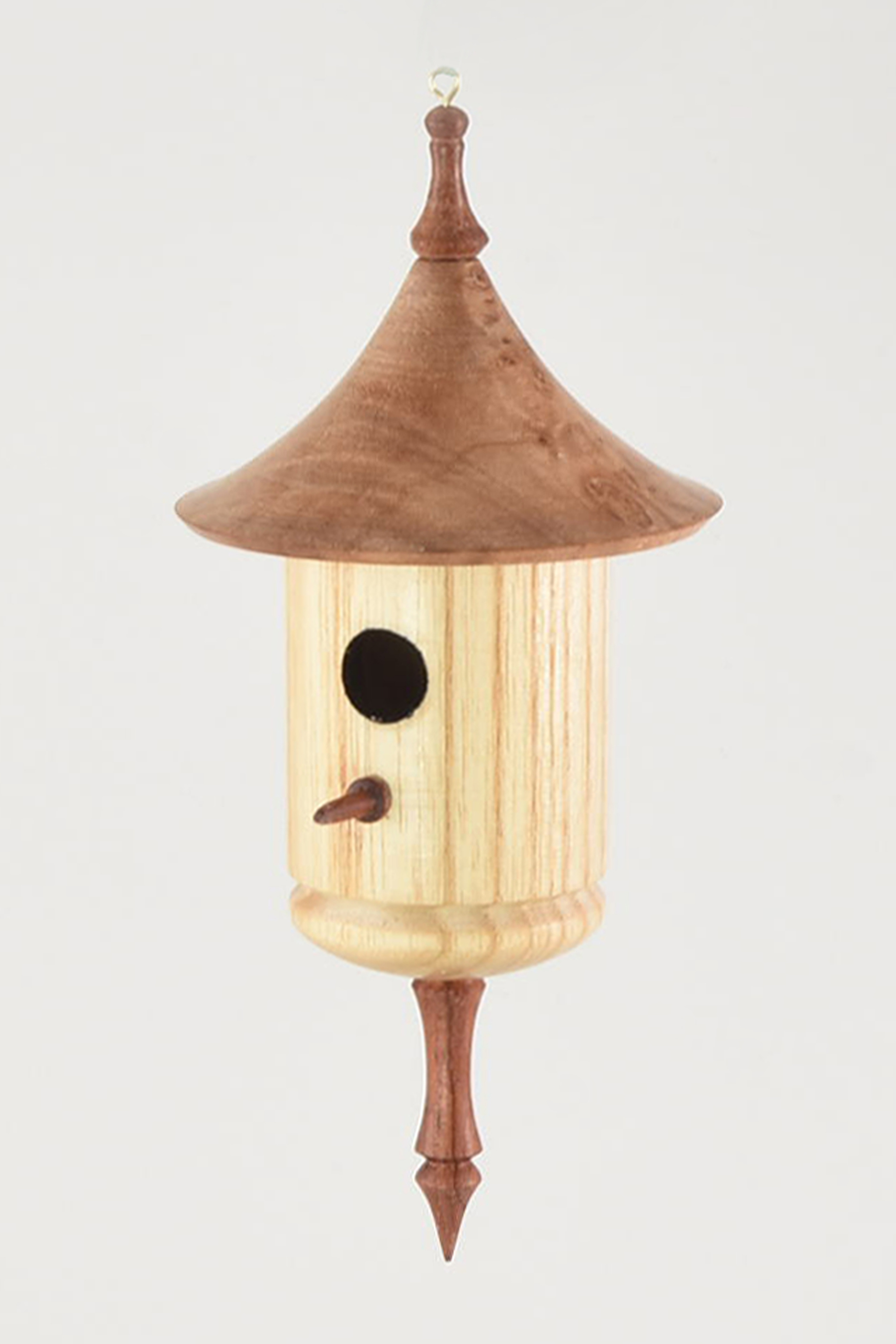 I’ve probably made 500 of these over last 10 years. I finish them in 30 minutes and they’ve been a steady seller for a long time. They are all the same size and use the same combination of materials. The roof is maple burl, the body is ash and the perch and finials are bubinga. I do them on a production basis. If our travel schedule allows it, I will be doing a HOW this year on this piece and a few other production items. -John H. Williams