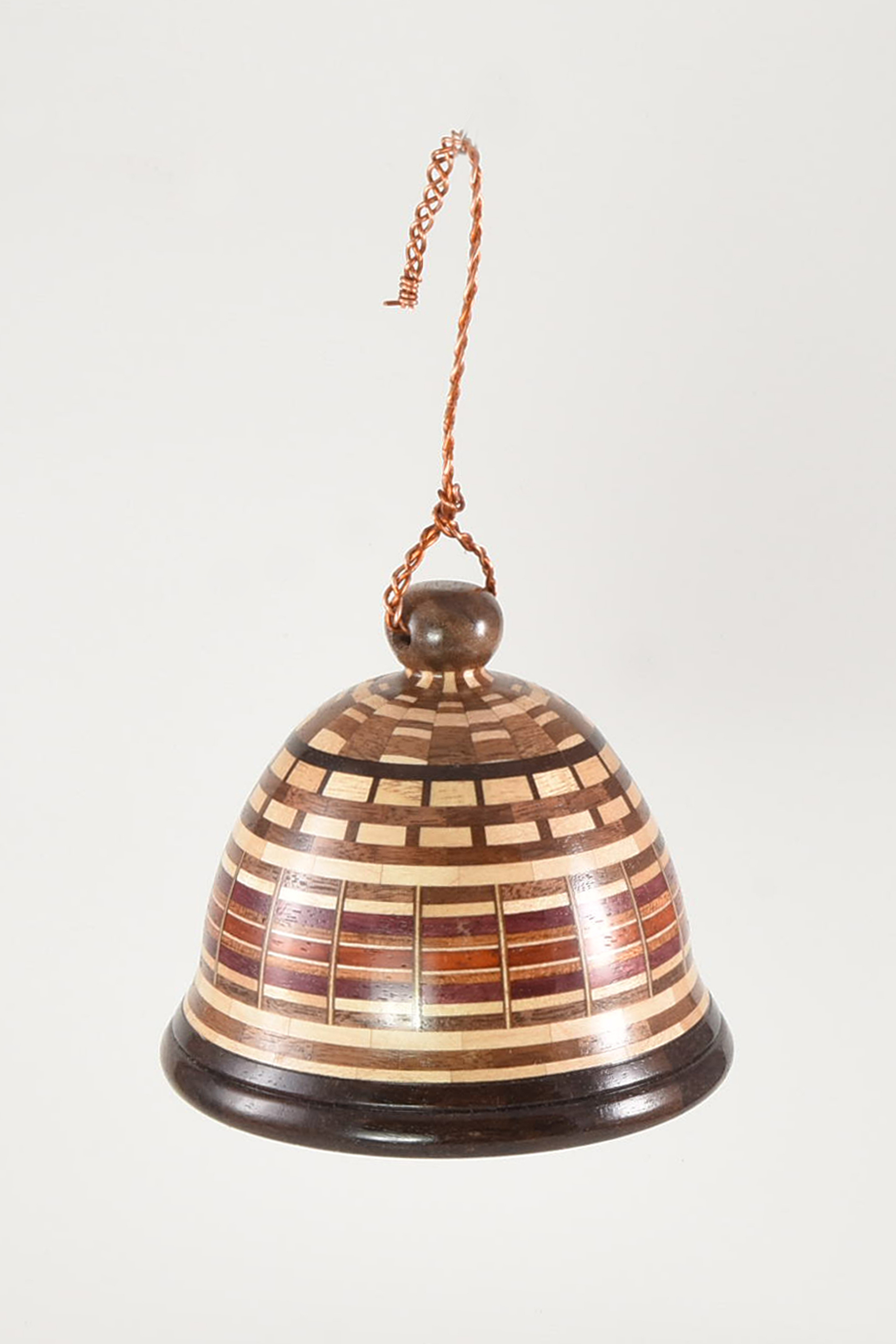 The 4.0” diameter segmented wood bell is made from walnut, maple, padauk and katalox woods. There are 18 segments per layer and the bell consists of a total of 540 wood segments. -John Manura
