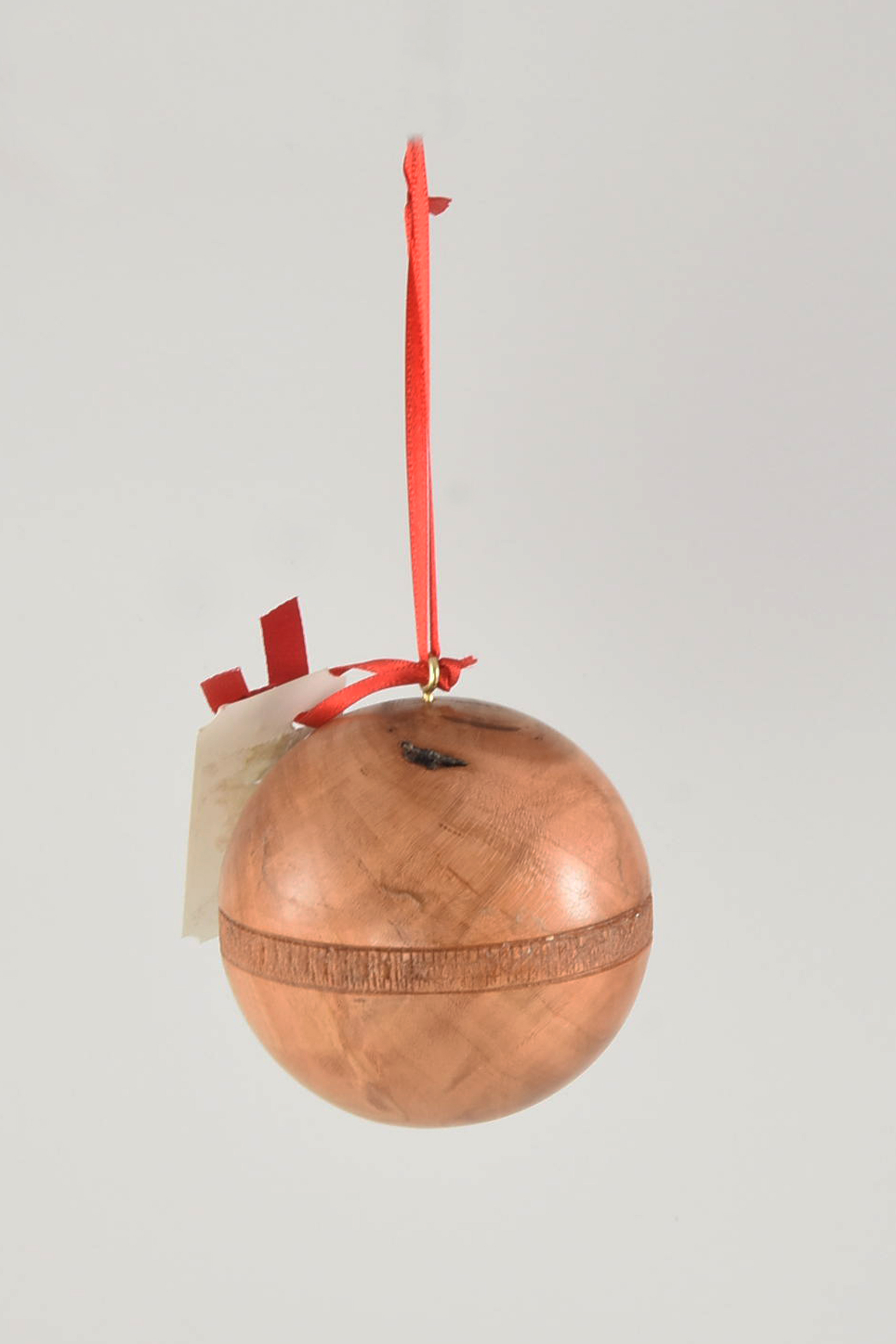 The Sealed Ornament Box That Rolls is made from firewood. The goal was to be able to place a small gift, like a ring or a necklace, in the secret, finished, compartment inside the sphere and not open inadvertently while hanging on the tree. This was more challenging for me than 2016 allowed. I will try again next year. -Keith Nelson