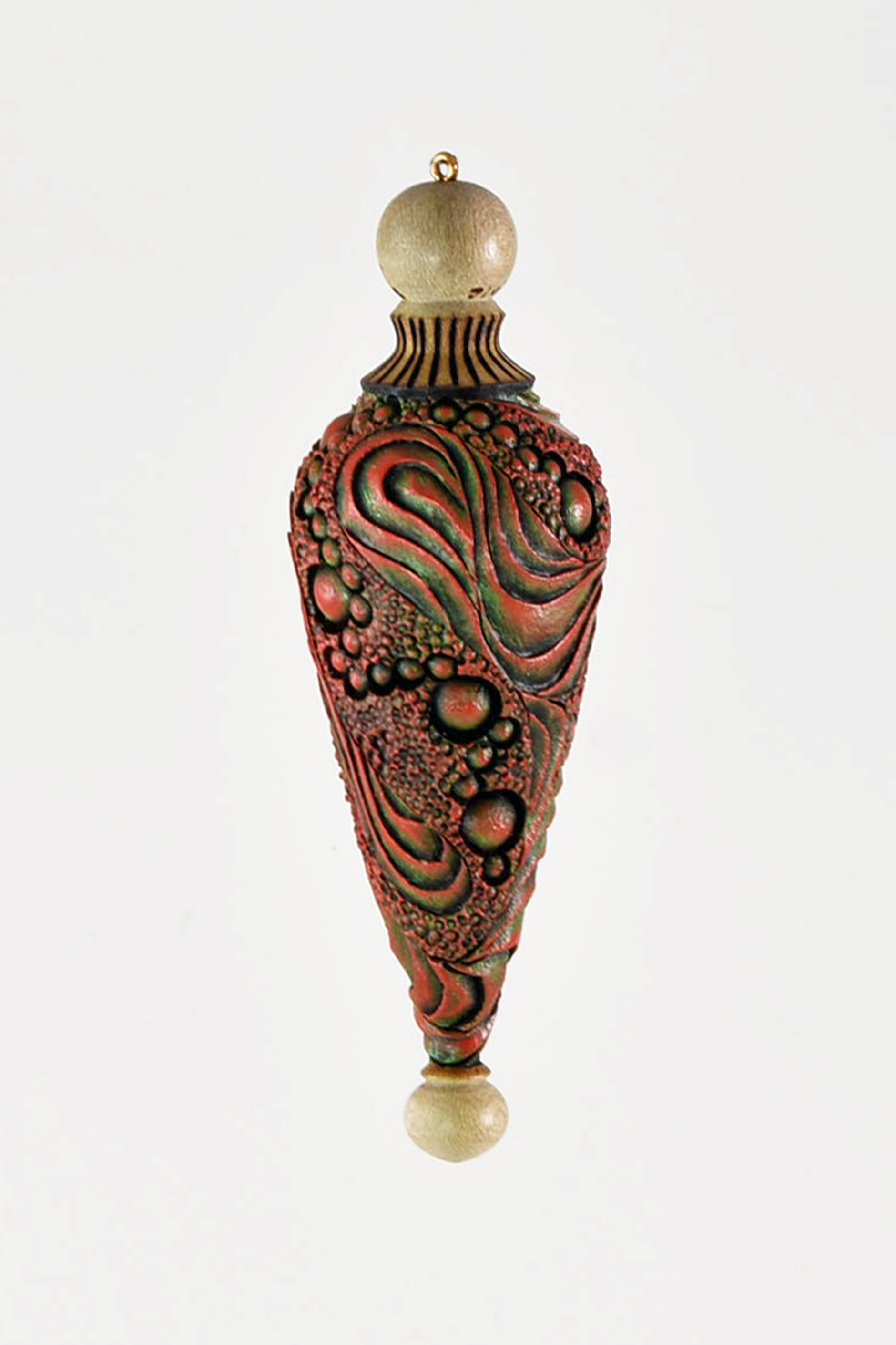 This ornament is Holly burn textured and colored with acrylic paint over india ink. -Michael Kehs