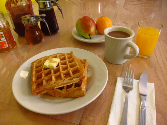  Start your day with breakfast in the kitchen served between 7am – 11am daily! And did we mention we always have freshly made waffles? A selection of breads, pastries, cereals, seasonal fruits as well as tea, juice and coffee are also available. 