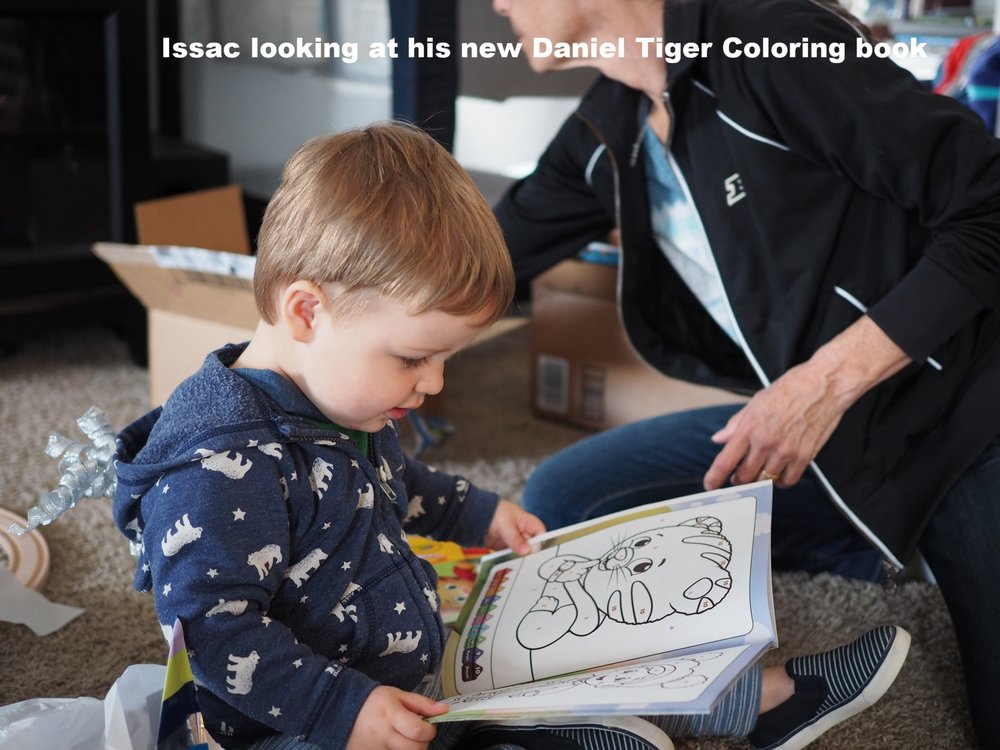 Isaac enjoying his new Daniel Tiger coloring book