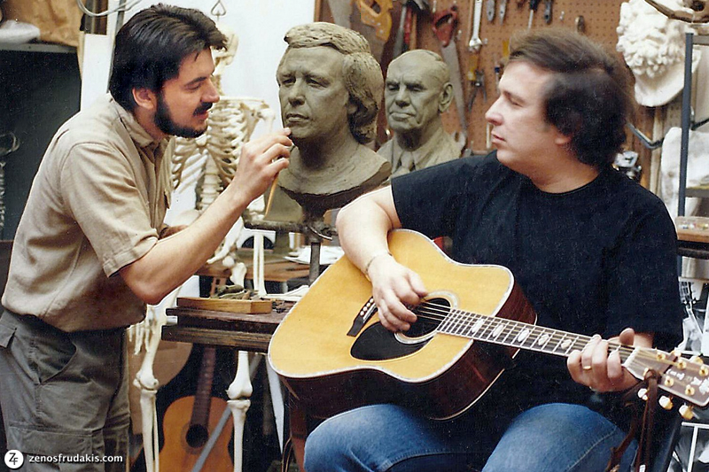  Don McLean sits with his guitar as Zenos Frudakis sculpts him. 