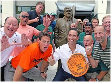 Former University of Miami Hurricanes team members gather round the statue of Ron Fraser (1933-2013), The Wizard of College Baseball, at the unveiling ceremony on April 24, 2015.