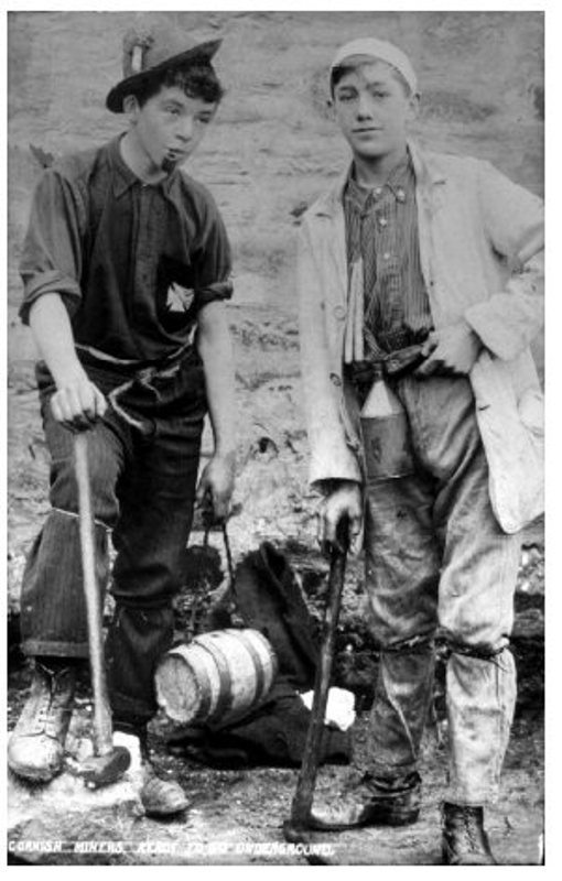 Boys working in the mines. Note the small wooden barrel lunchbox held by the boy on the left - likely containing a Cornish Pasty. Both boys have candles, which were used before electric lights to help the miners see underground. The boy on the left has attached a candle to his hat with a glob of clay, which was typical at the time. Source: Greever Tin Mine Museum website.