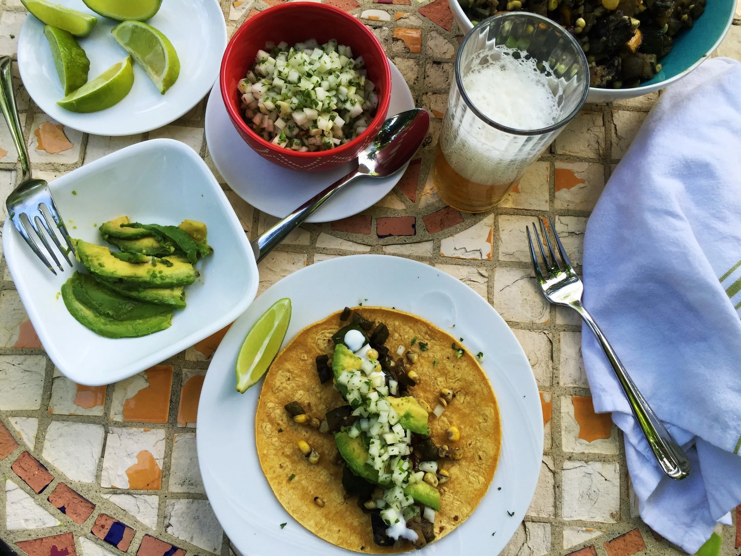 Tacos are ready, served with a cold beer.