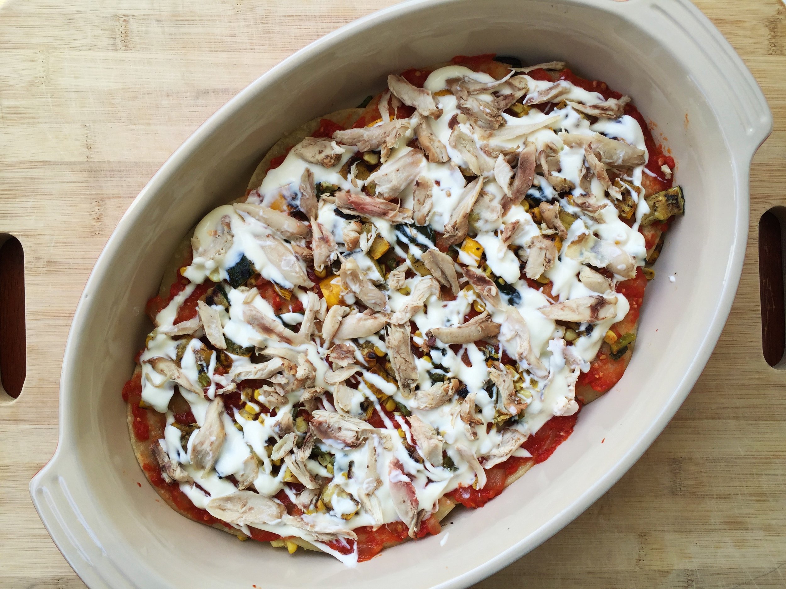 Half the chicken spread over the crema and vegetables.