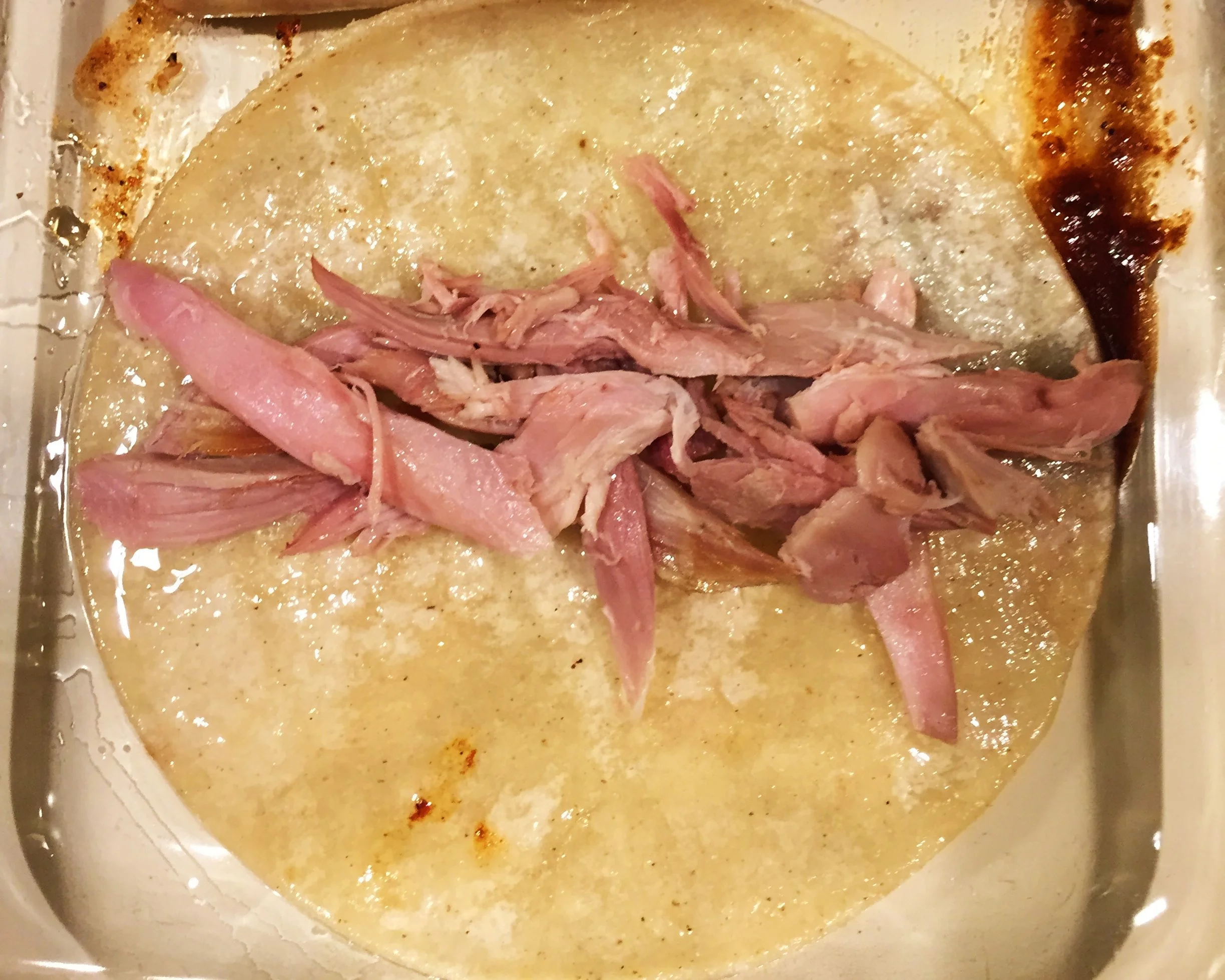 Shredded turkey spooned into the tortilla.