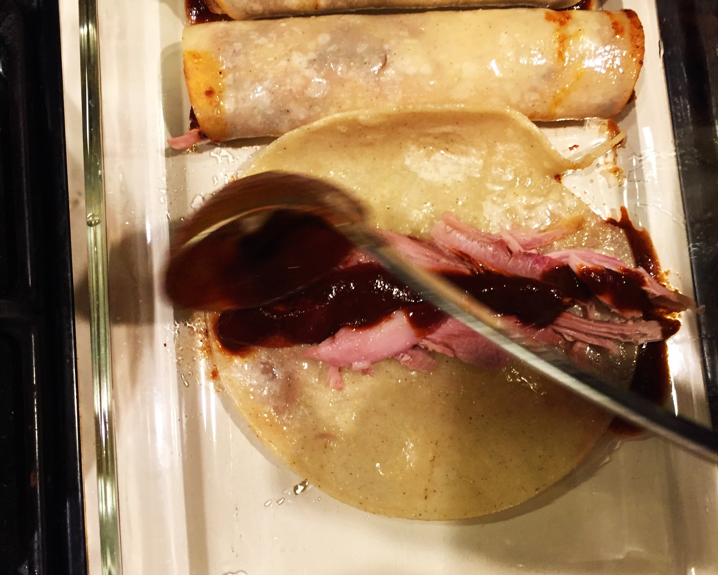 Ladling sauce over the turkey.