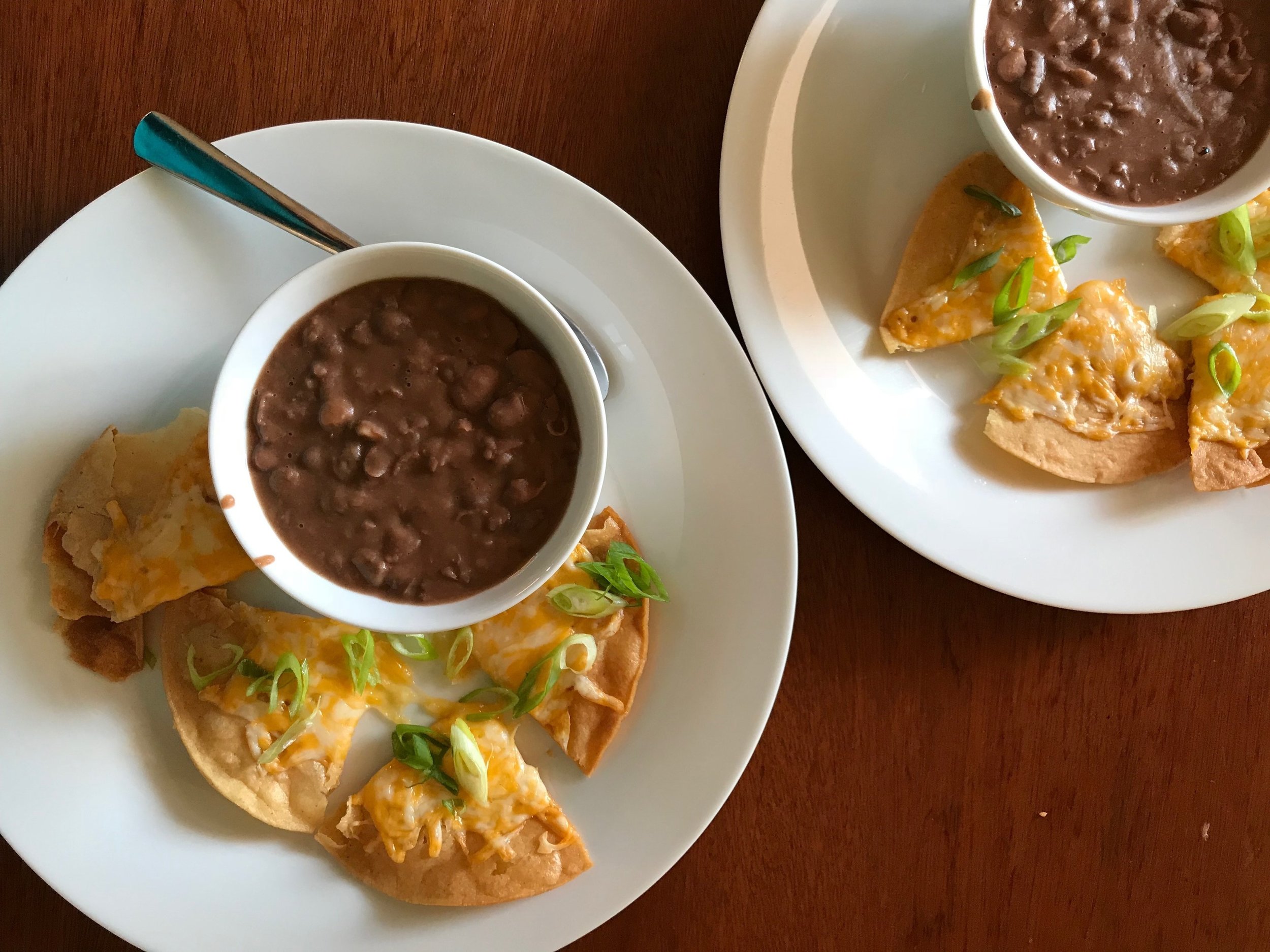 Leftover Mexican-style beans with leftover tostada shells topped with melted cheese and scallions. A dollop of salsa is great either in the beans or on the tostada pieces (or both!).