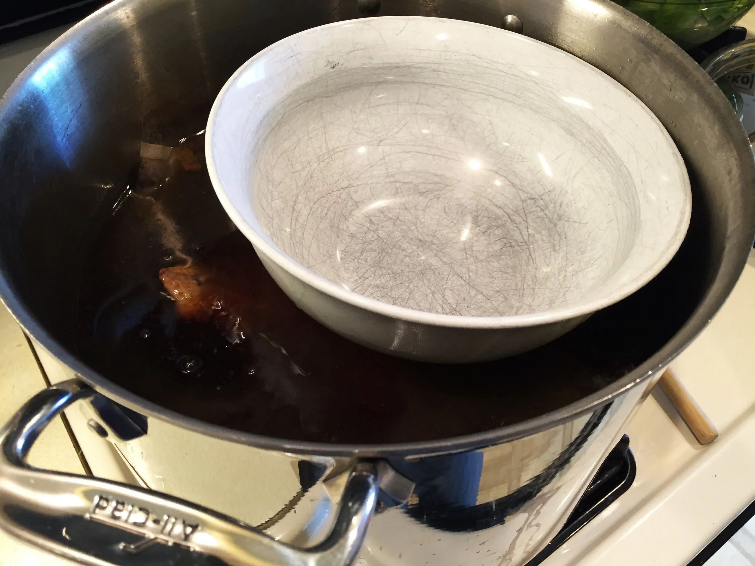 A sturdy porcelain bowl keeps the chicken submerged.