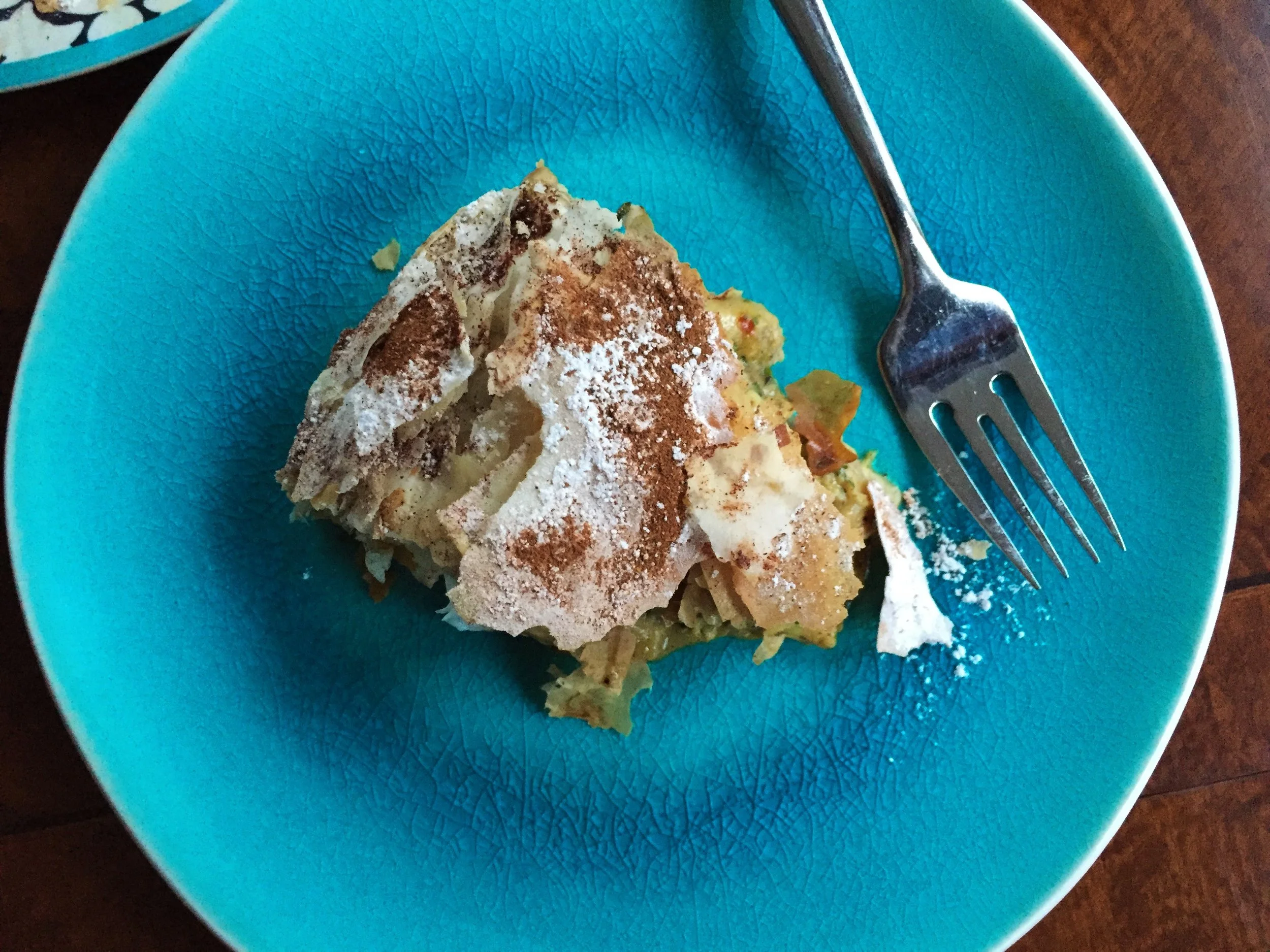 Slice of B'Stilla made in the Adventure Kitchen. Notice how the sugar and cinnamon are beginning to fall into the pie. This will continue to happen with every bite. Yum!