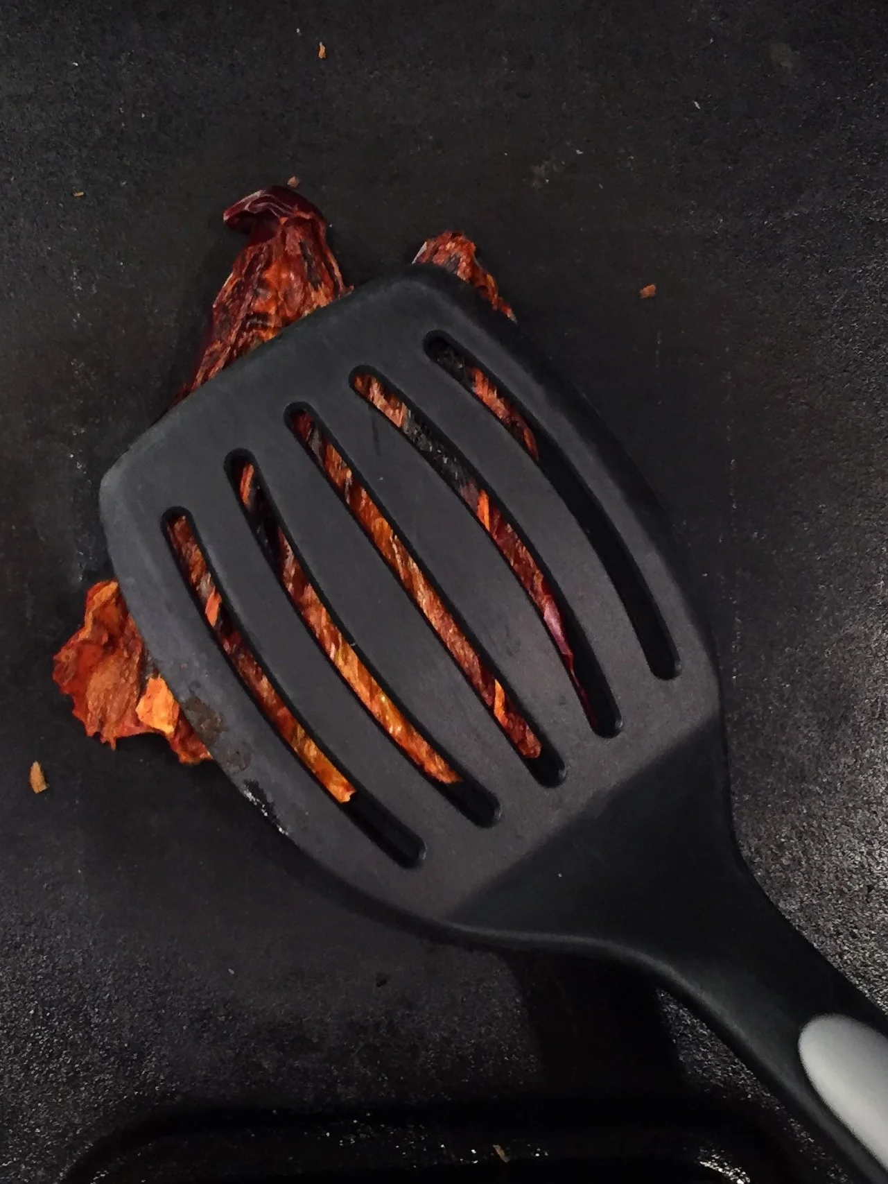 Toasting a guajillo chile, skin side down.