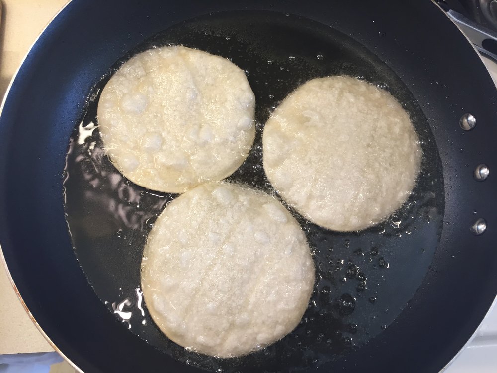 I bought this cheap extra-wide pan just for jobs like this, that require a lot of space, but not the finesse of more complicated dishes (it didn't even come with a lid!). Picture shows three tortillas frying at once, but I can actually fit four in this pan and fry up a dozen tortillas in less than 10 minutes.