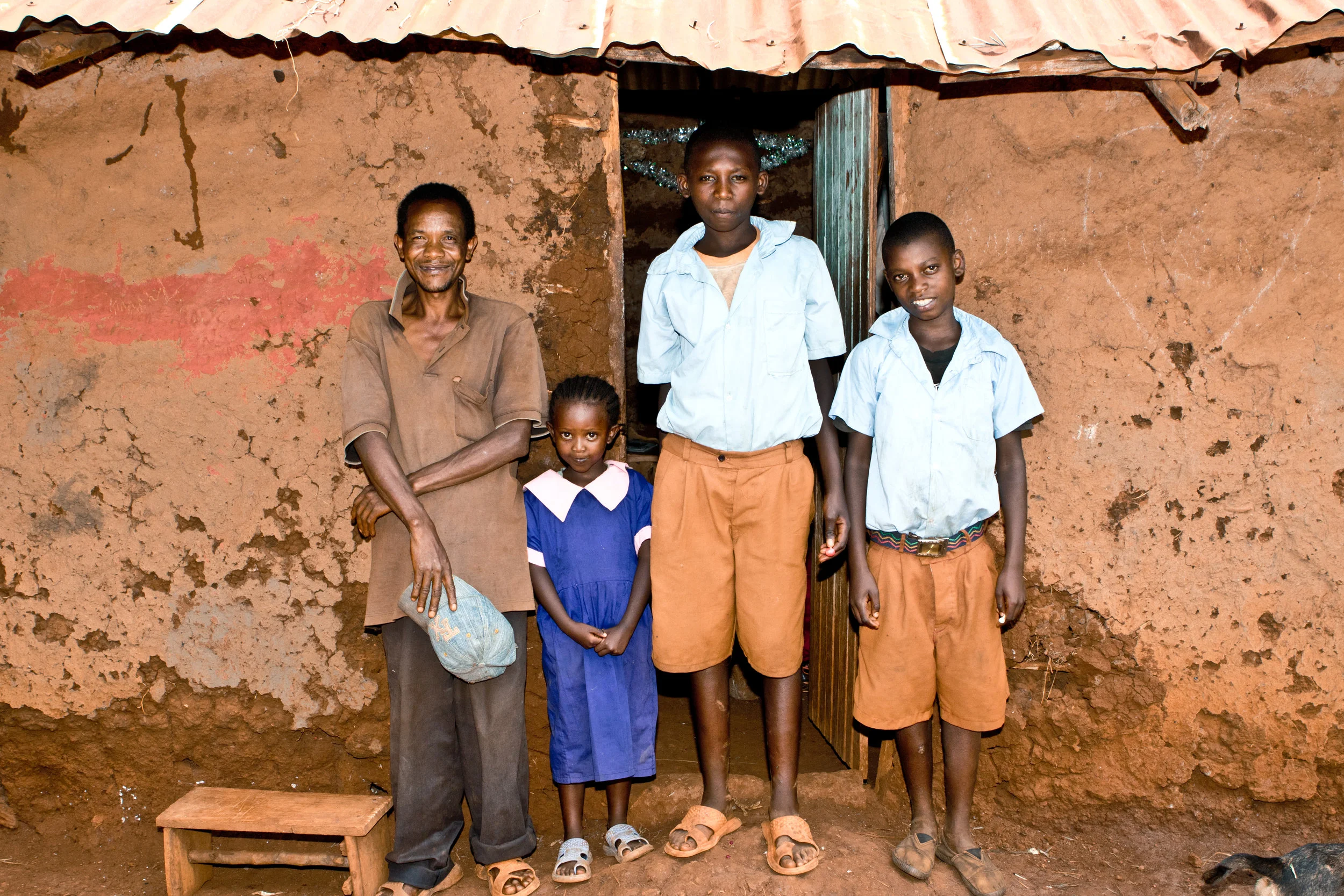 Jane's father, sister, and two brothers in front of their home.