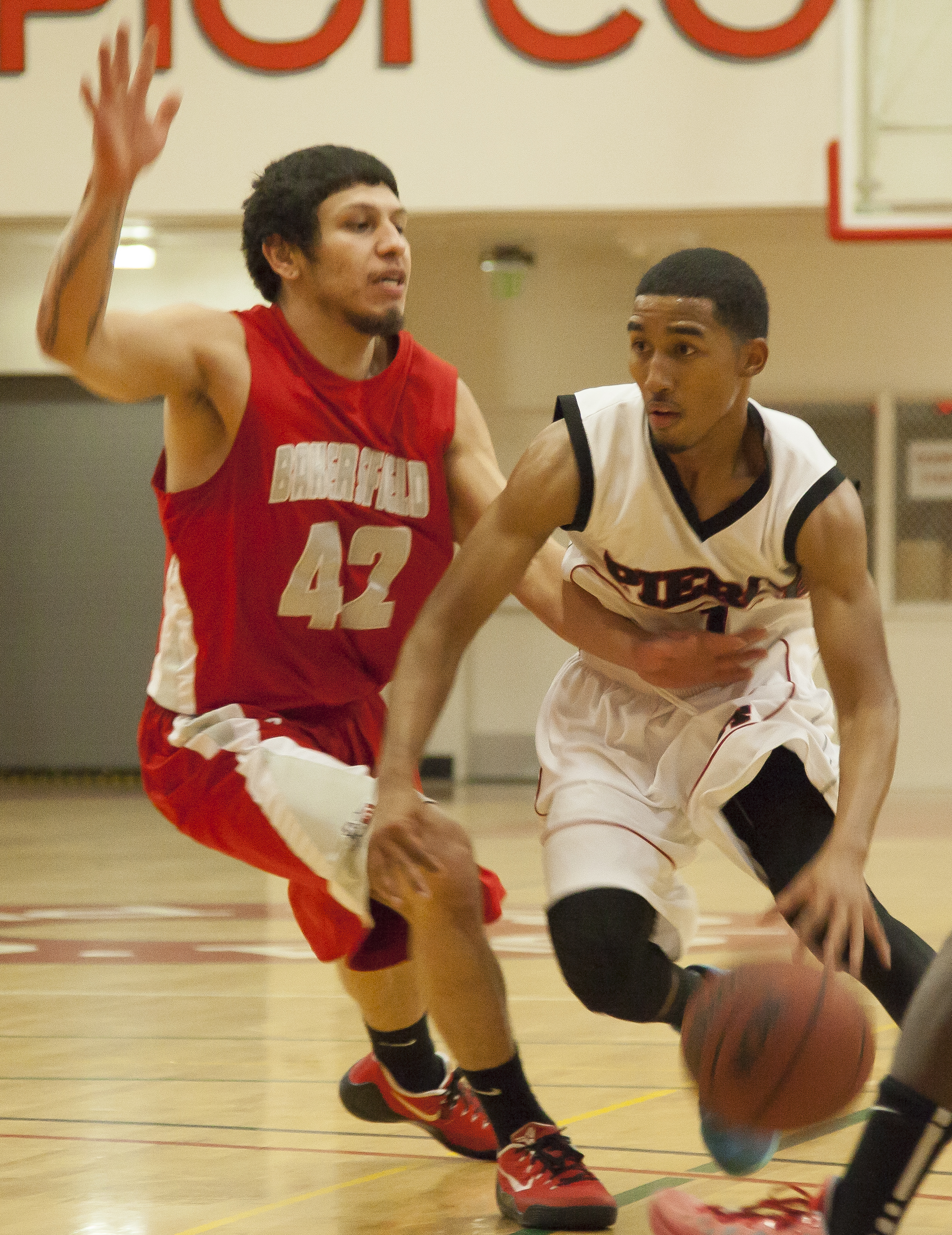  Pierce point guard JR Williams dribbles past Bakersfield guard Austin Welch during an important game that would determine who advances to the playoffs. Pierce would win the game in overtime, 95-92. Wednesday Feb. 25, 2015. Woodland Hills, Calif.  Fu