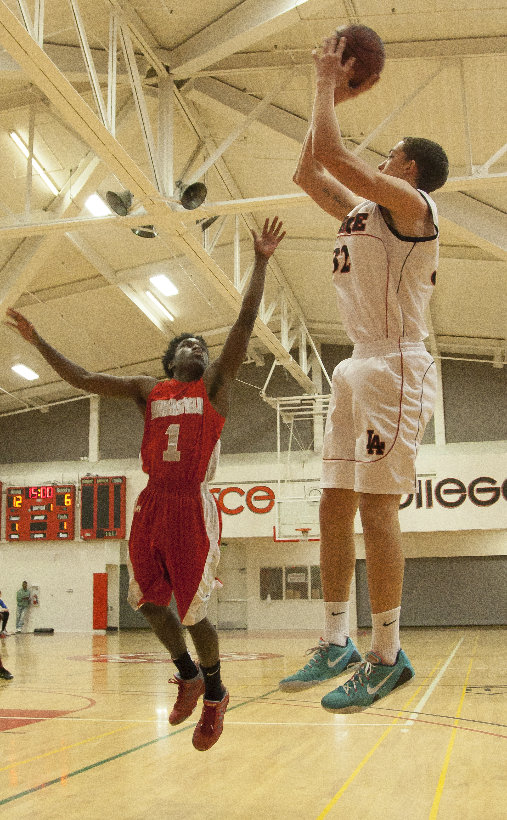  Pierce forward Trey Archambeau, shoots over Bakersfield College point guard Jameik Riviere in an important game that would decide which team advances to the playoffs. Pierce College would win the game in overtime, 95-92. Wednesday Feb. 25, 2015. Woo