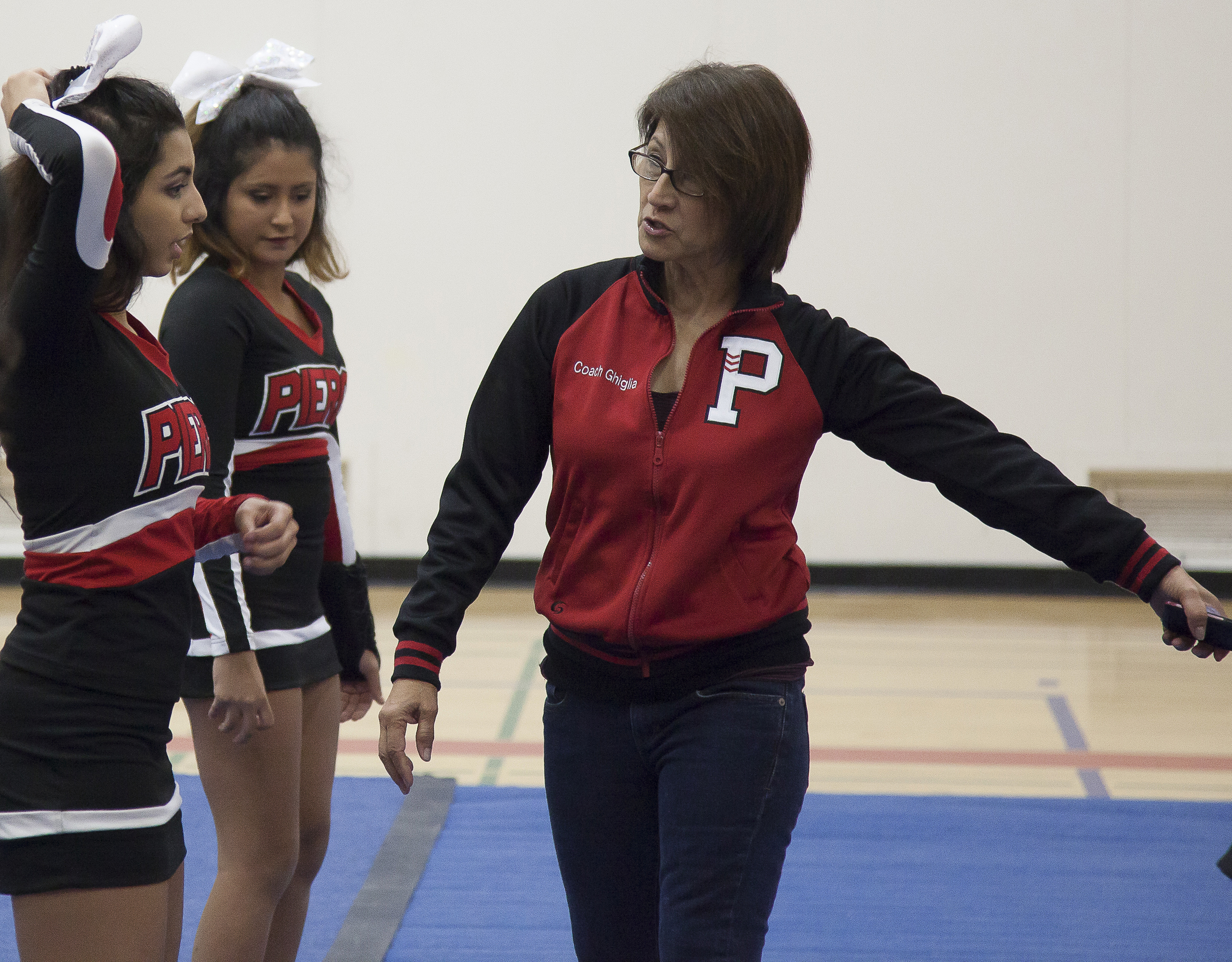  Cheer coach Jenny Ghiglia goes through the routine with Amanda Perez during practice in the North Gym on Sunday March 1, 2015. Woodland Hills, Calif.  Read the full story&nbsp; here  