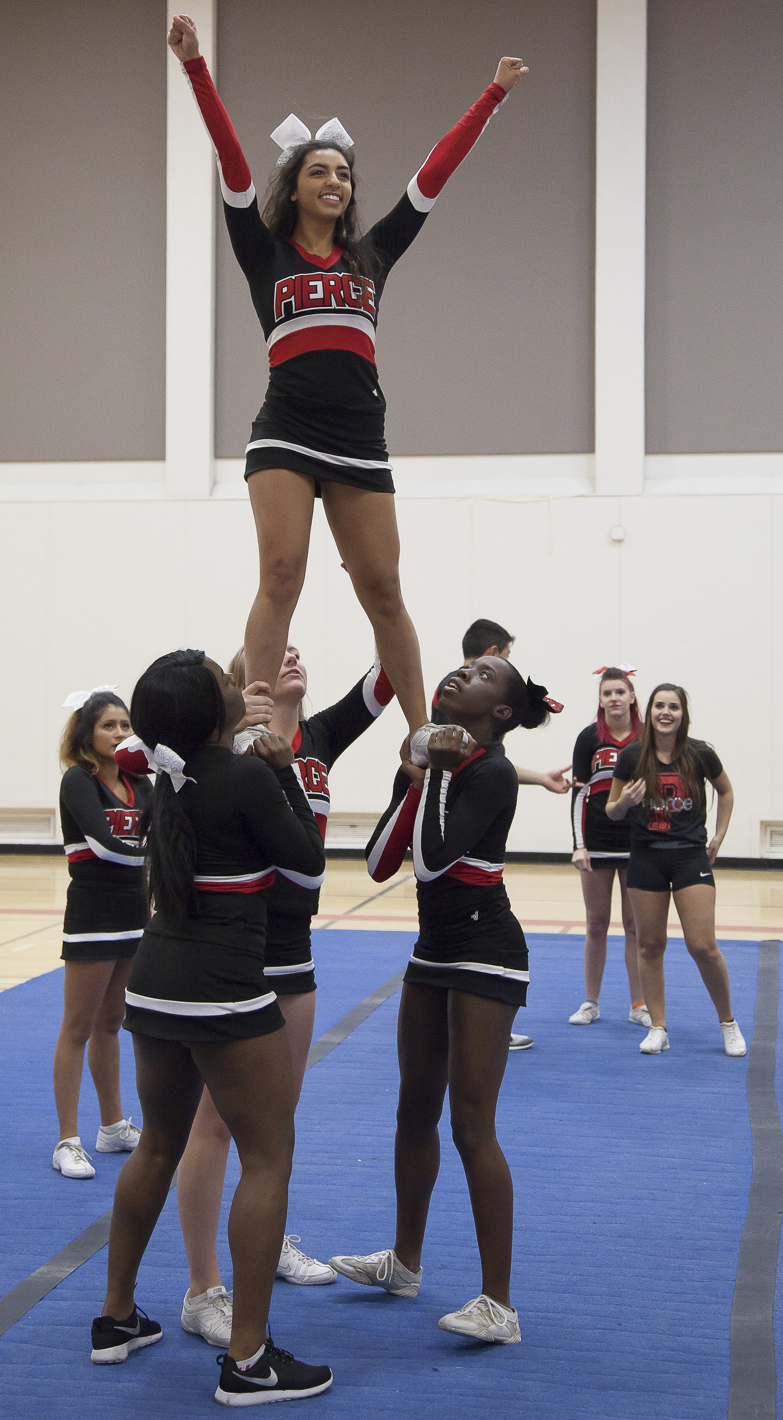  Amanda Perez, top, is lifted by fellow team members while other members watch inside the North Gym on Sunday March 1, 2015. Woodland Hills, Calif.  Read the full story&nbsp; here  