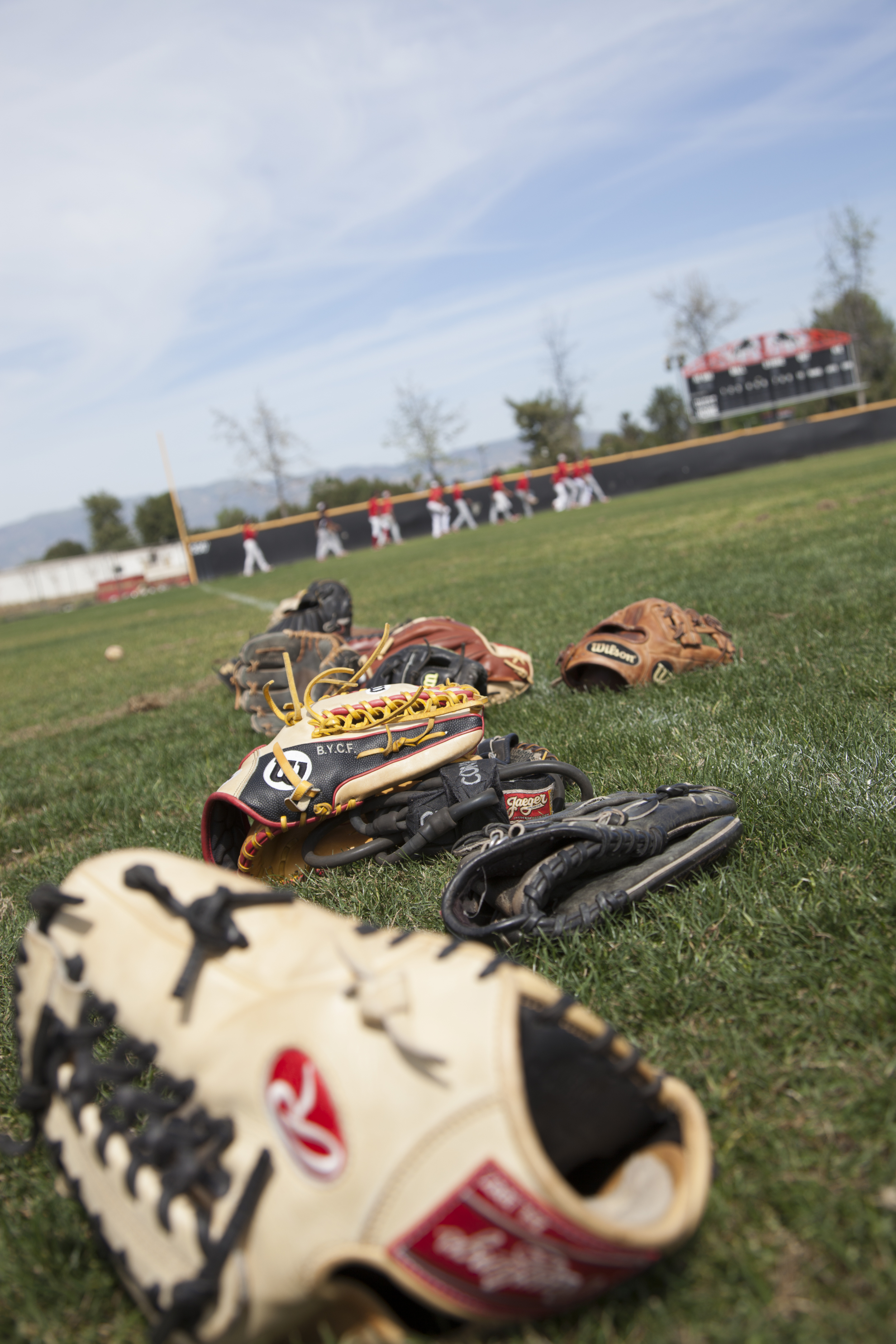  Gloves lay on the grass&nbsp;as the team practices in the background at Joe Kelly Field on Tuesday, March 10, 2015. Woodland Hills, Calif.&nbsp;  Read the full story&nbsp; here  